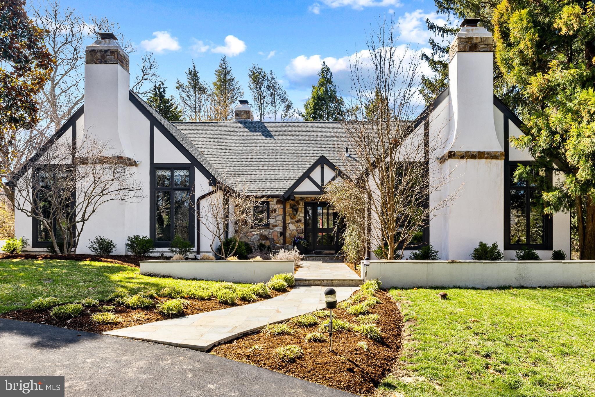 Approximately 4200 Sq Ft Nestled in Wynnewood’s most sought-after school district, this stunning English country estate blends timeless elegance with modern luxury. Designed by renowned architect Ann Capron and meticulously updated, this Tudor-style masterpiece sits on a private, lushly landscaped lot with a circular driveway and a completely redesigned heated pool.
Inside, exquisite craftsmanship shines with pegged hardwood floors, rich woodwork, and vaulted ceilings. The expanded family room features a dramatic stone fireplace, built-ins, and seamless indoor-outdoor flow. The all-new chef’s kitchen is a showstopper, boasting custom cabinetry, exquisite quartzite countertops, and top-of-the-line appliances.
The first-floor primary suite is a serene retreat with a fireplace and spa-like bath. Upstairs, additional bedrooms offer flexibility for guests or office space. Multiple off-leash hiking trails are just minutes away, making this home perfect for those who love both luxury and nature.
A rare opportunity to own a truly exceptional property in a premier location!