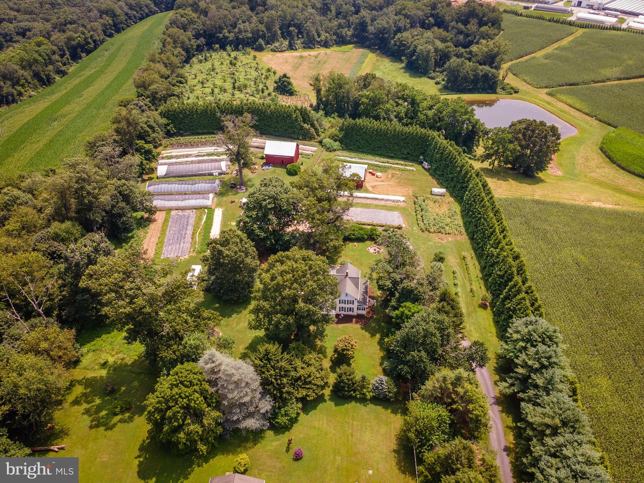OPEN HOUSE SUNDAY, SEPTEMBER 7TH FROM 2-4:30PM! Imagine waking up on your own Certified Organic Farm. Oak Spring Farm - perfectly intertwining an expansive, graciously restored farmhouse and in law suite with the different elements of a successful, thriving homestead business. Oak Spring Farm is a 4.4 acre Certified Organic Farm in Freeland, MD and your rare opportunity to own a dynamic, fully operational, profitable produce business with thriving Community Supported Agriculture (CSA) program, connecting the community with fresh, local, and organic produce on a weekly basis. Whether you're a seasoned grower or an aspiring homesteader, Oak Spring Farm is your chance to step into a business built on love, community, and sustainability. Please refer to full features and amenities list, or find extensive additional information on Oak Spring Farm's website and individual property site. 3-24'x84' high tunnels, heaters, a fully functional irrigation system, crop protection, large chicken coop, bee hive colony, perennials, and the fully outfitted wash/pack barn and supplies are just a few of the offerings provided by this robust property and business.
Step outside into pure tranquility. The property is mostly flat and bordered by tall, mature trees, offering privacy and peace. A large bank barn provides excellent storage, while the coop/drive-through shed offers a large, secure chicken coop and covered parking for tractors and equipment. The fully equipped wash/pack barn promotes efficient work flow with 2 walk-in coolers and plenty of storage. This building, at the center of the operation is a hub of activity and connection—used for washing, packing, storage, and showcasing the weekly harvest. The land has been thoughtfully designed and meticulously cultivated for diverse produce and perennial crops. The soil has been carefully cultivated for over a decade for peak production.
Oak Spring Farm is built on love, care, and intention. Every inch of it reflects a deep commitment to sustainability, beauty, and community. Now, it’s ready for its next steward.
The 5 bedroom, 3 full bathroom Victorian-style farm house is a joy, offering ample and flexible living space. Enter into the foyer with mudroom-style storage accents and bench with the laundry right ahead of you. To the left is the spacious, updated eat-in kitchen, with soapstone countertops, white cabinetry, double ovens, gas range, ample storage, and a wonderfully updated layout and style. There are two pantries off the kitchen. Also off the kitchen is the large, light-filled living room with vaulted ceilings. A first floor bedroom or office, recently renovated full bath, enclosed porch that is currently being used as an office, and dining room with access to the wrap around deck complete the main floor of the primary living space. Facing the driveway with 2 entrances is a large, vaulted ceiling in-law suite or apartment, with full bath, laundry hookup, and kitchen nook. A large in-law suite with private entrance, full bath, laundry hookup, and kitchenette—ideal for extended family, a farm manager, rental income, or private office Upstairs, find 3 large bedrooms, one with an extended walk in closet, and one with stairs up to attic access. The large bathroom is updated with a shower/tub combination. Historic charm reverberates throughout this house, including the front and back staircases, details in the molding, storage options, hardwood floors, high ceilings, trim work, and period-style doors. There’s room for everyone—whether you need multi-generational living, business space, or a cozy corner to call your own.
Oak Spring Farm has been lovingly stewarded and thoughtfully designed. It’s a place where community, purpose, and profit come together. If you’ve been looking for the opportunity to live and work on your land, this is it.
Oak Spring Farm is ready for its next chapter. Maybe it’s yours.