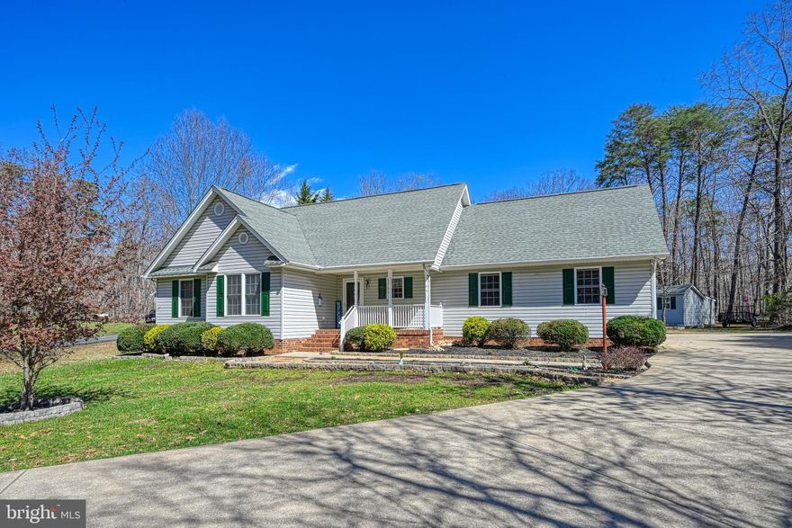 This is a really nice home with a great floor plan nestled on 1.13 private acres within the peaceful community of Lakeside Woods.  This beautiful 3 bedroom, 2 full baths, 1400 sf  home boasts cathedral ceilings in  both the  kitchen and family room. Your eat-in kitchen with tons of oak cabinetry is complete with refrigerator, built-in microwave & spice racks, dishwasher, range, laminate flooring , tiled backsplashes, and a farm sink with gooseneck faucet.  Your family room boasts a propane gas log fireplace & built-in entertainment center plus there's a sliding glass door to your 252 sf composite deck with built-in bench seating and vinyl railing.  Relax on your back deck while enjoying expansive wooded views ... a great place to cook dinner on the grill and hang out with family and friends.  Extras include:  A finished 2 car 576 sf end loading garage with deep sink, 2 garage door openers and side garage door to backyard, Crystal Right water softener conveys, 14x10 shed with lean to, 10x10 metal shed, 200 amp service with 50 amp generator hookup, arched thru ways, washer & dryer convey, ceiling fans, double hung dual pane vinyl windows, covered front porch,  gutters and downspouts, vinyl soffits, architectural shingles, Dutch lap siding, brick skirt, flood & recessed lighting, lovely landscaping including holly bushes, oak, birch & crepe myrtles.  There is a fortune in concrete driveway, patio and walkways on this property and plenty of space to keep your boat or RV.  Launch your boat, jet ski, kayak or paddleboard a short distance away into Valentine Cove via the community boat ramp.  Your property is conveniently located near the dam across from Pleasants Landing Marina and El Gran Patron lakefront restaurant.  There's great fishing down by the dam and you can watch the July 4th fireworks by boat that are shot off from nearby dike 2.  This is a wonderful area to walk your dog and get together with great neighbors.  HOA fee is $400 per year or about $33 per month and there's a community waterfront pavilion and dock.  Property is serviced by Rappahannock  Electric and Comcast Xfinity internet.  Nearby county trash disposal.  Seller is offering a one year 2-10 Home Warranty to the proud new owners!  Come Quick!