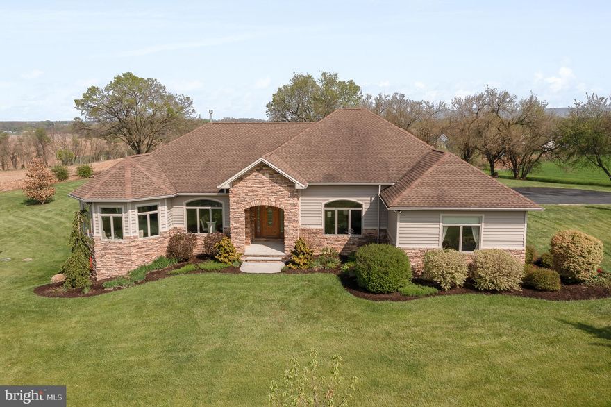 This elegant, modern ranch-style home is located on 15.42 scenic acres.  The main level boasts a large open concept floor plan.  The kitchen island is large enough to seat 6-8.  In addition to the formal dining area, is an additional casual dining area with a beverage bar and wine cooler.  The kitchen looks onto the substantially sized living room with a fireplace framed by custom built-ins.   The four-season room looks onto the patio and fenced back yard.  There are 9’ ceilings throughout the home and 10’ lighted tray ceilings in the master bedroom and bath, living room, dining, kitchen, office/4th bedroom and the en suite.  The main floor has 4,174 square feet with 4 bedrooms and 3 full and 1 half bath.  The side entrance of the home walks into a large mud room with ample counter and cabinet space.  

Check out the website for this listing which shows the floor plan!

The oversized 3-car garage has a garage heater, (2) 9’ doors and (1) 10’ door.

The full finished, walk-out  basement could be an in-law/nanny apartment, and is perfect for social gatherings.  It has a complete custom kitchen with bar seating.  This lower-level kitchen has a gas stove, dishwasher, and refrigerator.  In addition to the theater, pool table, and gaming area, the basement has a full-sized gym, an additional bedroom and full bath, a mechanical room with ample storage, and a separate storage room perfect for wine keeping.  

For the horse enthusiast, there are 8 acres of pasture with 3 board vinyl fencing and a riding arena with jumps.  If you are not using the pasture and riding arena, it would provide opportunity for rentable income.  The property is in the clean and green program thus resulting in lower taxes.  
There are many additional items of importance to mention about this home from the construction to the mechanicals.