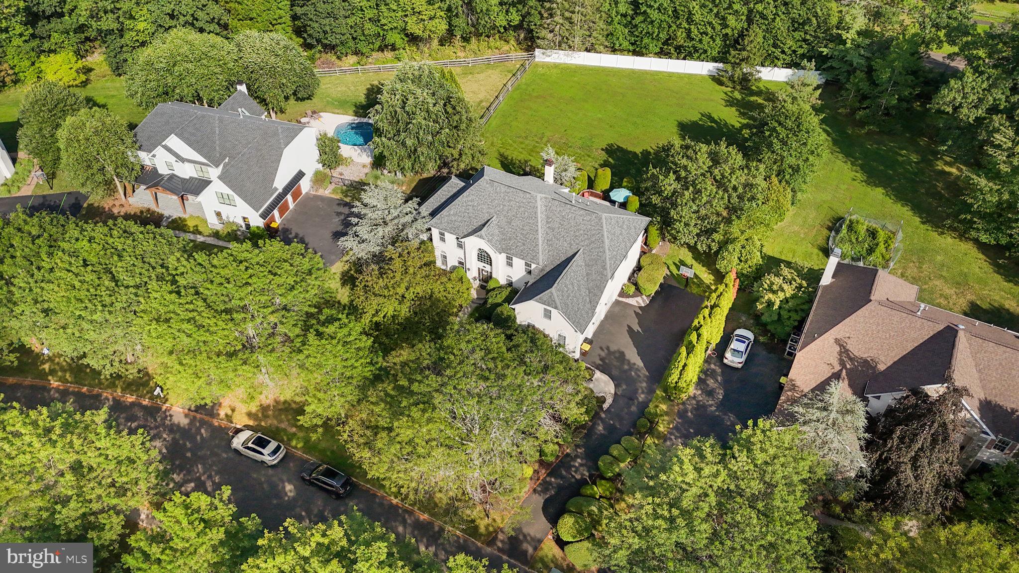 Welcome to this stunning residence in the highly sought-after community of The Oaks of Buckingham.
This 4-bedroom, 4.5-bath home offers over 4,790 square feet of beautifully designed living space, plus a finished lower level with nearly 2,000 additional square feet—all set on a private homesite surrounded by natural beauty.
As you enter, a dramatic butterfly staircase and abundant natural light create a grand first impression. To the left, the formal living room opens to both the rear study and the magnificent 14' x 29' conservatory. With its vaulted ceilings and walls of windows, the conservatory is a versatile space that can serve as a sunroom, music room, or elegant entertaining area. The rear study offers quiet seclusion, ideal for working from home.
At the heart of the home, the two-story family room boasts a soaring stone fireplace and flows seamlessly into the breakfast room and chef’s kitchen. The kitchen is a true culinary delight, featuring classic white cabinetry, granite countertops, a center island, stainless steel appliances, and gas cooking. Sunlight streams in from the adjoining morning room, where oversized windows frame panoramic views of the backyard and its abundant wildlife—a perfect setting for your morning coffee.
To the right of the foyer, the formal dining room provides an inviting space for hosting memorable gatherings. Completing the main level is a spacious mudroom with access to the three-car garage and backyard, along with a conveniently located powder room.
Upstairs, accessed by both front and rear staircases, you’ll find a breathtaking view overlooking the family room and the outdoor scenery. The primary suite is a true retreat, offering a private sitting room, a tray-ceilinged sleeping area filled with natural light, and a luxurious en-suite bath. A double-door entry welcomes you into a spa-like space featuring an elevated soaking tub framed by a picture window, a stall shower, and dual vanities. The second bedroom enjoys its own en-suite bath, while the third and fourth bedrooms share a Jack & Jill bathroom with dual sinks. All bedrooms are generously sized and filled with light.
The lower level expands the home’s versatility with 1,949 square feet of additional finished space, including a gym area, bedroom, full bath, cedar closet, and abundant storage.
Outdoors, a spacious deck (2025) invites you to relax or entertain while enjoying the natural surroundings. The backyard is partially fenced and offers ample space for recreation and gardening. Outdoor sprinkler system provides convenience to keep your yard green year round. Also, a central Vac system for added ease and benefit.
All of this comes with the benefit of an exceptional location—just minutes to historic Doylestown’s restaurants, shops, commuter routes, and the award-winning Central Bucks School District. You are also a walk or bike ride away from Bush Park or Hansel Park.
