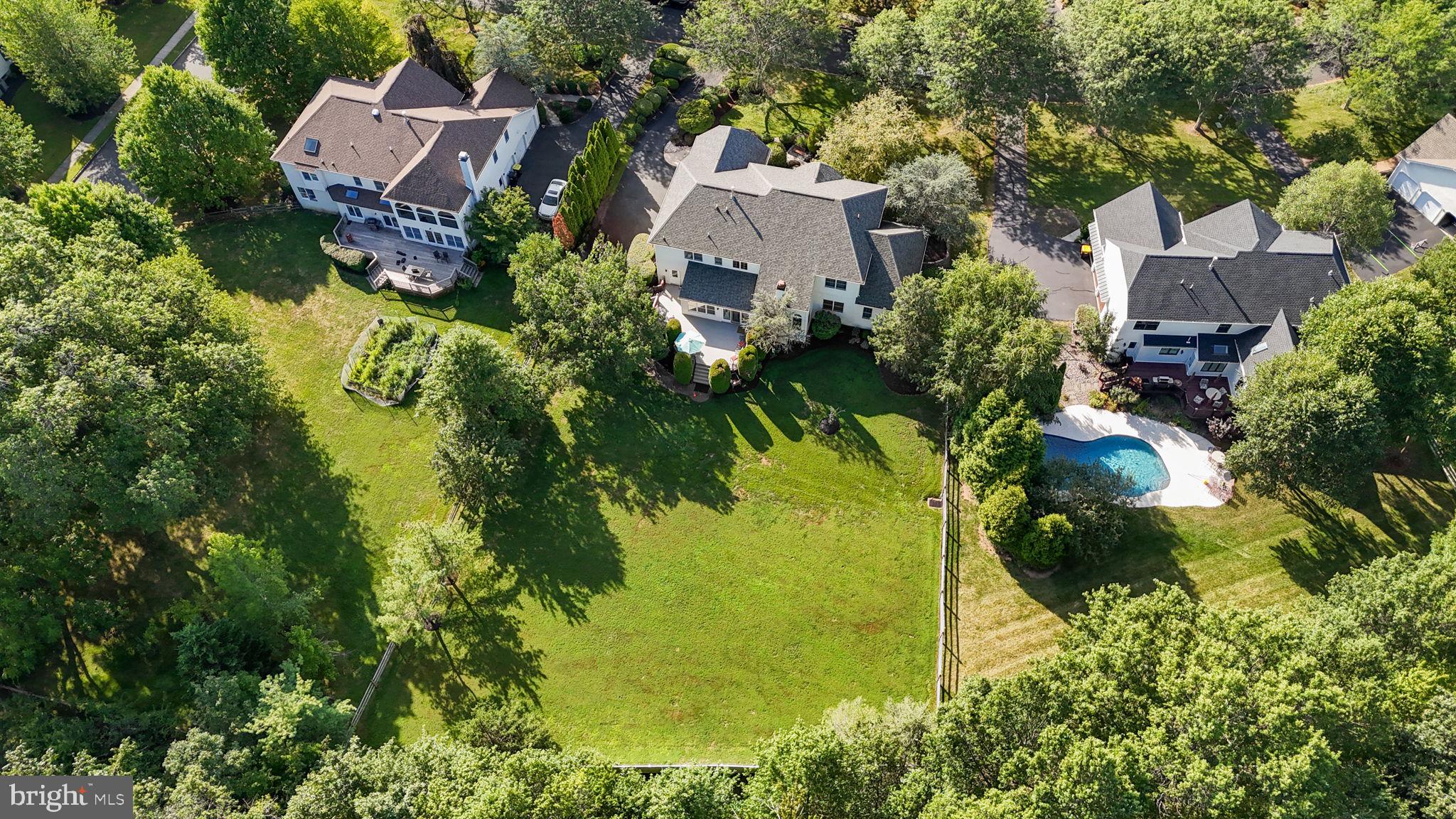 Welcome to this stunning residence in the highly sought-after community of The Oaks of Buckingham.
This 4-bedroom, 4.5-bath home offers over 4,790 square feet of beautifully designed living space, plus a finished lower level with nearly 2,000 additional square feet—all set on a private homesite surrounded by natural beauty.
As you enter, a dramatic butterfly staircase and abundant natural light create a grand first impression. To the left, the formal living room opens to both the rear study and the magnificent 14' x 29' conservatory. With its vaulted ceilings and walls of windows, the conservatory is a versatile space that can serve as a sunroom, music room, or elegant entertaining area. The rear study offers quiet seclusion, ideal for working from home.
At the heart of the home, the two-story family room boasts a soaring stone fireplace and flows seamlessly into the breakfast room and chef’s kitchen. The kitchen is a true culinary delight, featuring classic white cabinetry, granite countertops, a center island, stainless steel appliances, and gas cooking. Sunlight streams in from the adjoining morning room, where oversized windows frame panoramic views of the backyard and its abundant wildlife—a perfect setting for your morning coffee.
To the right of the foyer, the formal dining room provides an inviting space for hosting memorable gatherings. Completing the main level is a spacious mudroom with access to the three-car garage and backyard, along with a conveniently located powder room.
Upstairs, accessed by both front and rear staircases, you’ll find a breathtaking view overlooking the family room and the outdoor scenery. The primary suite is a true retreat, offering a private sitting room, a tray-ceilinged sleeping area filled with natural light, and a luxurious en-suite bath. A double-door entry welcomes you into a spa-like space featuring an elevated soaking tub framed by a picture window, a stall shower, and dual vanities. The second bedroom enjoys its own en-suite bath, while the third and fourth bedrooms share a Jack & Jill bathroom with dual sinks. All bedrooms are generously sized and filled with light.
The lower level expands the home’s versatility with 1,949 square feet of additional finished space, including a gym area, bedroom, full bath, cedar closet, and abundant storage.
Outdoors, a spacious deck (2025) invites you to relax or entertain while enjoying the natural surroundings. The backyard is partially fenced and offers ample space for recreation and gardening. Outdoor sprinkler system provides convenience to keep your yard green year round. Also, a central Vac system for added ease and benefit.
All of this comes with the benefit of an exceptional location—just minutes to historic Doylestown’s restaurants, shops, commuter routes, and the award-winning Central Bucks School District.