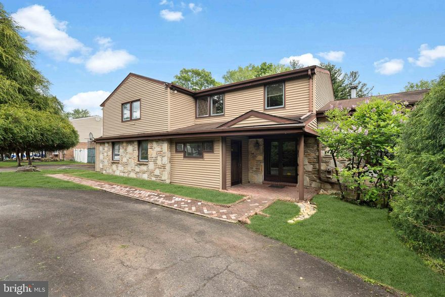 Situated on a generous half-acre lot in a prime location within the highly sought-after Lower Moreland School District, this expansive split-level residence offers exceptional space, versatility, and endless potential. A grand governor’s driveway leads to an oversized private parking area, while a separate side entrance provides the perfect opportunity for an in-home business, private office, or future in-law suite.

Step inside through the impressive foyer and immediately appreciate the home’s spacious layout. To the right, a formal living room filled with natural light from a large bay window seamlessly connects to the formal dining room, creating an ideal setting for entertaining. Adjacent to the dining room is the oversized kitchen featuring custom oak cabinetry throughout, a dedicated breakfast area, and a charming corner wine bar. The kitchen overlooks the expansive backyard and opens through oversized sliding glass doors to the outdoor living space.

Beyond the kitchen, the inviting family room showcases a striking floor-to-ceiling granite stone wall with a wood-burning fireplace and custom built-in shelving, creating a warm and welcoming atmosphere. Continuing further, the four-season sunroom offers walls of sliding glass doors that provide direct access to the backyard and private tennis court. A full bathroom and office spaces complete the first floor, offering incredible flexibility for today’s lifestyle needs.

Upstairs, you’ll find four generously sized bedrooms, each with ample closet space. The oversized primary suite features elegant double-door entry, his-and-her walk-in closets, potential access for a future private balcony, and a stunning custom-built en-suite bathroom. The luxurious primary bath includes an oversized Jacuzzi tub, an open walk-in glass block shower, and an expansive vanity with dual sinks and a dedicated makeup area. Two additional bathrooms, and three linen closets complete the second floor, including a hall bathroom remodeled in 2021.

The fully finished basement, completed in 2021, adds even more functional living and entertaining space. Outside, the expansive backyard offers endless possibilities, highlighted by a private tennis court ready for your personal touch and updates.

With incredible square footage, unique architectural features, and outstanding potential, this is a rare opportunity to create your dream home in one of the area’s most desirable neighborhoods.