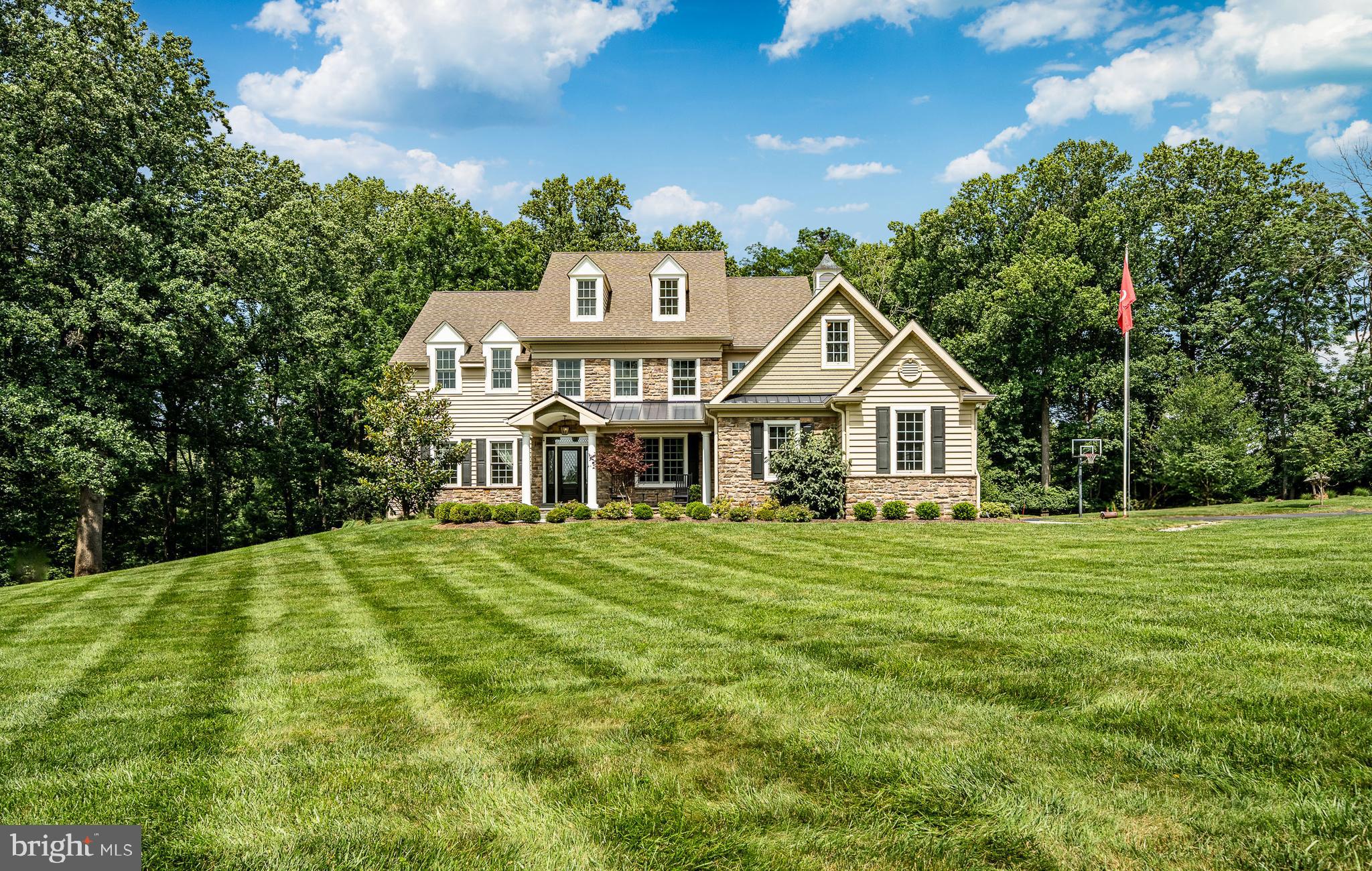 Luxury Living Meets Timeless Charm in the coveted Radnor Hunt subdivision of Willistown Township! The endless opportunities begin at 211 Dutton Mill Road—an extraordinary, custom-built estate designed with sophistication, versatility, and multi-generational living in mind. Privately tucked away on a lush, level lot in the heart of the award-winning Great Valley School District, this luxurious property includes two distinct residences and a striking converted barn, offering endless potential for a wide range of lifestyles. Expertly designed by acclaimed architect McIntyre Capron and built by Mullray Builders, the main home exudes modern luxury across more than 6,800 square feet of expertly finished living space. From the moment you arrive, meticulous craftsmanship and high-end finishes are evident throughout. A flagstone path leads to an elegant entry flanked by formal spaces that feature transom windows, crown molding, and wainscoting. The heart of the home is the expansive chef's kitchen—complete with top-tier stainless appliances, a generous center island with seating for four and above pendant lighting, abundant cabinetry, and a warm breakfast room with slate-surround fireplace and custom shutters. The kitchen flows seamlessly into a dramatic family room showcasing vaulted ceilings, a floor-to-ceiling stone fireplace, and two-story windows that flood the space with natural light. French doors lead to the rear deck with greenery all around you. The first-floor primary suite is a serene retreat with a fireplace in the main quarters and offering a private sitting room , dual walk-in closets, and a spa-like bathroom featuring a striking copper soaking tub, walk-in tile shower with custom stone niche, and separate vanities. Upstairs, you'll find four additional ensuite bedrooms, as well as thoughtfully designed spaces for work, play, and hobbies—including a built-in study area and a dedicated craft room. Custom "hideouts" can be found for family fun or secret storage spaces. The finished walk-out lower level is perfect for entertaining, with a custom stone wet bar and ample space for media, fitness, or recreation. Outside, the property is framed by manicured gardens, dramatic landscape lighting, and mature trees, creating a truly private oasis. Make your way down the extended driveway & you will enter the secondary residence. Perfectly suited for multi-generational living, completely updated second home offers true one-floor living with 3 bedrooms and 1.5 bathrooms. Whether used as in-law quarters, guest accommodations, or a private home office, this residence provides comfort and flexibility , all surrounded by mature landscaping and open yard space. A standout feature of this property is the expansive converted barn, a multifunctional structure that’s ideal for entertaining, storing collectibles, or housing a car enthusiast’s dream garage. Whether you're hosting unforgettable gatherings or seeking additional storage, this space delivers both style and function. Nestled in one of Chester County’s most desirable school districts, this estate offers the rare combination of luxury, privacy, and convenience With quick access to major commuter routes and just minutes from the vibrant towns of Malvern, West Chester, and the Main Line this is the home you've been dreaming of. .