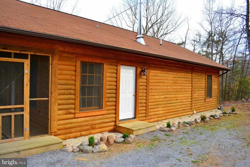 Over $10,000 in upgrades, this log cabin feels like new construction! Fully equipped at list price, inc: dining room suite, brand new hot tub, window treatments, 1940 s walnut handmade 4 poster bed, bedroom furniture, pots, pans, linens-est at over $6,500! Vaulted ceilings, tile floors, 15x8 screened porch, wood stove, mountain views! Nat l forest 300 yards away! Well insulated 9 true log walls!