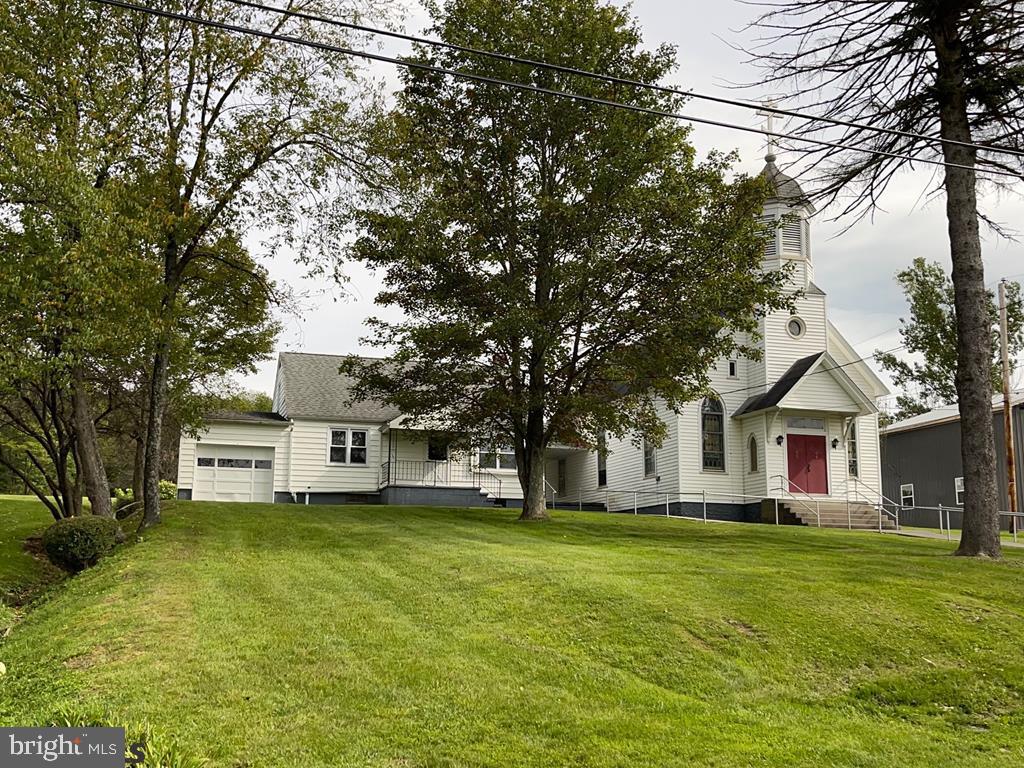 Perfect opportunity to own 3 buildings for under 100K. This property includes a 2 bedroom, 1 bath ranch home, a church, a large hall plus plenty of parking. So many options and potential with this one. With a little work, you could turn this property into anything to fit your needs. Property is being sold "as-is".