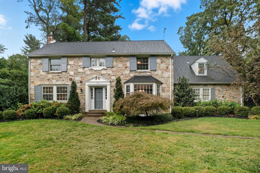 Welcome to 615 Mulford Road in wonderful historic Wyncote! This classic center-hall colonial offers timeless charm and modern updates in a secluded neighborhood setting. From the stately columns that welcome you into the community to the expansive front lawn and extra-long driveway with space for multiple vehicles, this home makes a grand first impression. Inside, over 3,800 square feet of living space features a traditional layout thoughtfully updated over the years. The formal living room boasts a stone wood-burning fireplace, recessed lighting, hardwood floors, and abundant natural light. Across the foyer, the spacious dining room is perfect for hosting holidays, celebrations, or casual meals.The rear of the home has a more relaxed, open feel. The updated kitchen features granite countertops, abundant cabinetry, and a breakfast bar that flows seamlessly into the cozy den with freshly painted built-in bookshelves and french doors to the back patio and private yard. A versatile bonus room off of the den is ideal for a home office, playroom, or workout space and includes a door for added privacy. A convenient powder room completes the main level. Upstairs, the primary suite has been freshly painted and offers hardwood floors, multiple closets, and an ensuite bath with stall shower. Two additional bedrooms with hardwood floors share a full hall bath. A fourth bedroom and another full bath are accessible from the back staircase—perfect for guests or an au pair. The basement was just finished (Sept 2025) with stylish luxury vinyl plank flooring and a brand-new powder room. You’ll also find laundry and additional unfinished space for storage. A two-car attached rear garage and extra-long driveway make parking effortless. Set on nearly half an acre, the property offers plenty of no worry outdoor space (with the updated front retaining wall and enhanced outdoor lighting) to garden, play, or simply relax. 615 Mulford is just minutes from downtown Glenside, Keswick Village, and Jenkintown, with easy access to regional rail, Arcadia University, Ancillae-Assumpta Academy, Route 309, and other major roadways. Make your appointment today to see 615 Mulford Road—this beautiful home is ready to welcome its next owners!