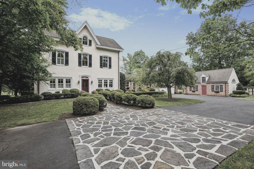 500 Swedesford Road is a transcendent piece of local history. You will be awed at the lengths current owners went to, to meticulously update, manicure, and maintain this stunning homestead with love and pride. The structures were built using materials from 1800's. The main house is plaster over stone, the breezeway,  garage and barn are brick and the walled courtyard is the plaster over stone. The circular drive, 3 car garage,  slate walkway, and lush landscaping greet you as you begin to get a feel for all that this home offers.  Enter from  the right entrance into the heart of this home, the family kitchen-great room.  No detail was spared in bringing this room up to todays lifestyle.  Imagine gathering,  cooking, eating, and cozying up to a warm fire,  while  viewing  your rolling  property, a view that will not change as the property is bordered by Natural Land Trust and Wissahickon Watershed. The raised ceiling,  cozy bay window, and striking fireplace will  be the place your family will for hours and hours. The kitchen will inspire the cook and baker hiding inside all of us with its updated cherry cabinets including a spacious desk area for planning, a convenient island that seats 3, and chefs stainless appliances.  A large laundry-entry room, sunny powder room,  and garage access sit steps away.   Ascend the staircase from the kitchen to a private retreat. You will be charmed by the dormer windows,  custom built-ins and full bath.  Imagine the fun sleepovers or perhaps  a private office.  Some of the home's finest features are;  its large and plentiful windows,  deep windowsills, substantial moldings and trim, which are all all tastefully highlighted with quality paint in classic colors. To the left of the kitchen,  pass through the exposed stone wall,  to enter your formal dining room resplendent with wainscoting,  striking windows, and beautiful lighting.  Picture hosting dinner parties and Sunday family suppers. What a  magnificent flow for entertaining  with fabulous property views  from every room.  After dinner you and your guests can make your way into one of two cozy yet graceful rooms. The formal living room houses the homes original fireplace, built- in shelves and more bright windows. The den across the hall features a built-in entertainment-office  unit,  the perfect spot for family movie night on your giant sofa. The center hall and stairs are original to the home. Here, you'll also find the original front door, where you might  greet guests.  Imagine  decorating this home for each season and holiday! After all the fun you've enjoyed downstairs lets head upstairs to view the spaces for sleeping and resting.  A large bedroom awaits you at the top of the stairs across from which you will find a fully updated bathroom. The primary suite sits at the back of the hall and exudes peace and tranquility with a luxury  spa  feel.  Custom cabinetry,  embellished tile, and a his and hers walk in closet add convenience to the plushness. Heading up to the third floor you will pass another fabulous window. The third  floor features two more large bedrooms and a smaller room boasting  a large cedar closet.  This room could function as an office or perhaps an art studio.  A large updated hall bath services this floor.  Wait there's more... The stunning patio with covered section runs the length of the house. You'll enjoy this space with the beautiful landscaping and custom stone retaining walls with flower boxes.  It is accessible from every room in the back of the house. There's even a stone well which the owners have tastefully covered with slate. From this wonderful slate porch you'll enjoy peaceful times gazing at your own paradise. The large pond is fed from the well and contains a gang of koi, gorgeous plantings, and a babbling waterfall you can hear from the patio. The home sits in the award winning Wissahickon School District  with easy access to Rts 202, 73, and the PA turnpike. Welcome to your forever home.