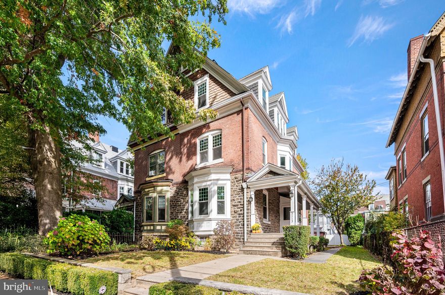 Step into history with this stunning 3-story twin, built in 1900 of Wissahickon schist, stone, and brick, perfectly situated on a wide lot in desirable Southwest Germantown. Offered for the first time in 48 years, this beautifully maintained 5-bedroom, 3.5-bath home is a rare find, spanning over 3,000 square feet and showcasing thoughtful upgrades throughout. Enjoy mornings on the inviting wrap-around mahogany front porch, then enter through the charming, bright vestibule and welcoming entry foyer. The home features hardwood flooring with exquisite walnut inlay trim, high ceilings, and original architectural details in the crown moldings, staircase, banisters, and around each fireplace. The spacious living room includes a gas fireplace and custom wood pocket doors leading to a formal dining room with crown molding and a built-in buffet cabinet. The renovated eat-in kitchen offers custom cabinetry, porcelain flooring and backsplash, granite countertops, and stainless-steel appliances, along with a private staircase to the second floor. A tiled laundry room and remodeled powder room complete this level, along with rear access to a fenced brick patio and green backyard. The second floor includes three comfortable bedrooms and two full baths, including a primary ensuite renovated in 2019. The two additional bedrooms offer generous closets and natural light. A full hallway bath features updated flooring, trim, and vanity. The third floor boasts two additional bedrooms and a full bath, remodeled in 2024, providing flexible living space—perfect for guests or a home office. The unfinished basement offers ample storage and potential for future finishing. All knob-and-tube wiring has been replaced, and the home includes seven window A/C units. Roofs and built-in gutters have been updated over the years. The extra-wide, landscaped yard is ideal for entertaining, gardening, or relaxing. Enjoy a vibrant neighborhood with access to Hansberry Community Garden, the John B. Kelly Elementary meadow and vegetable garden, Friends of Fernhill Park, the historic Germantown Cricket Club, Attic Brewery, Merzbacher’s Bakery, and the new Weavers Way Co-op. Convenient to public transportation, including SEPTA rail stations at Wayne Junction, Queen Lane, and Chelten Avenue, as well as multiple bus routes. Just a 15-minute drive to Center City with easy access to Roosevelt Boulevard and I-76. Come experience the timeless charm and modern comfort of 5113 Pulaski Avenue!