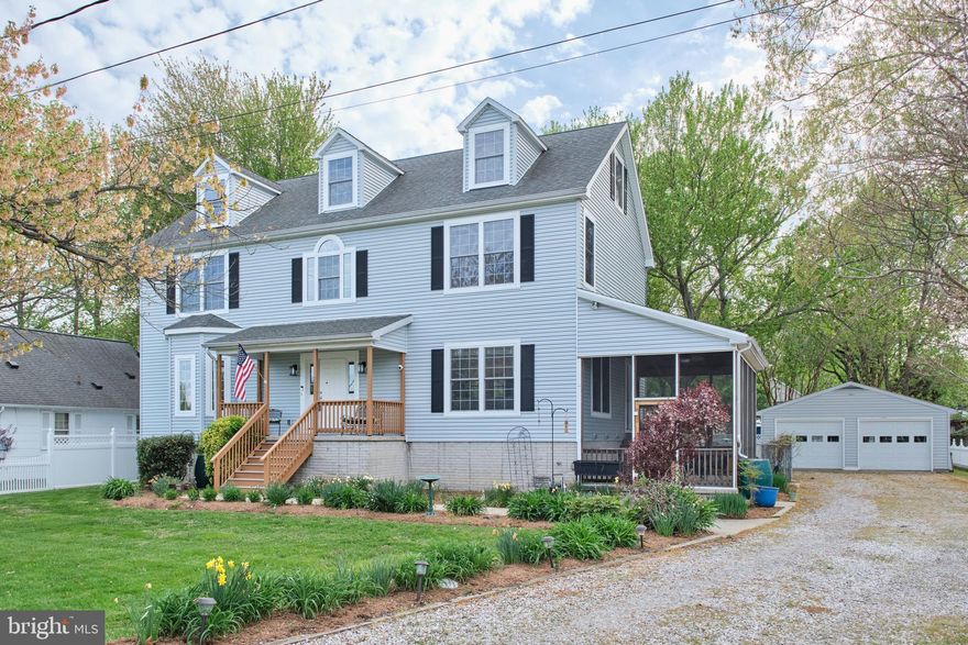 Light-filled home on two lots with open Chesapeake Bay views, set outside the flood zone. Spacious layout offers  2,600+ sf across two finished levels, with 4 bedrooms and 2.5 baths. Main level includes flexible space to create a bedroom and full bath. Bright primary suite features a walk-in closet. Quality details throughout: mahogany floors, crown molding, and abundant windows. Unfinished third floor ( 1,100 sf) with bay views and bath rough-in offers expansion potential. Outdoor living includes screened porch, rear deck with ramp, and fenced yard. Built in 2008 with raised foundation, dual-zone HVAC, two 200-amp panels, backup generator, and 39 owned solar panels for efficiency. Oversized detached 2-car garage (720 sf). Enjoy nearby piers, beaches, boat ramp, and waterfront park in a vibrant community. One-year home warranty included.