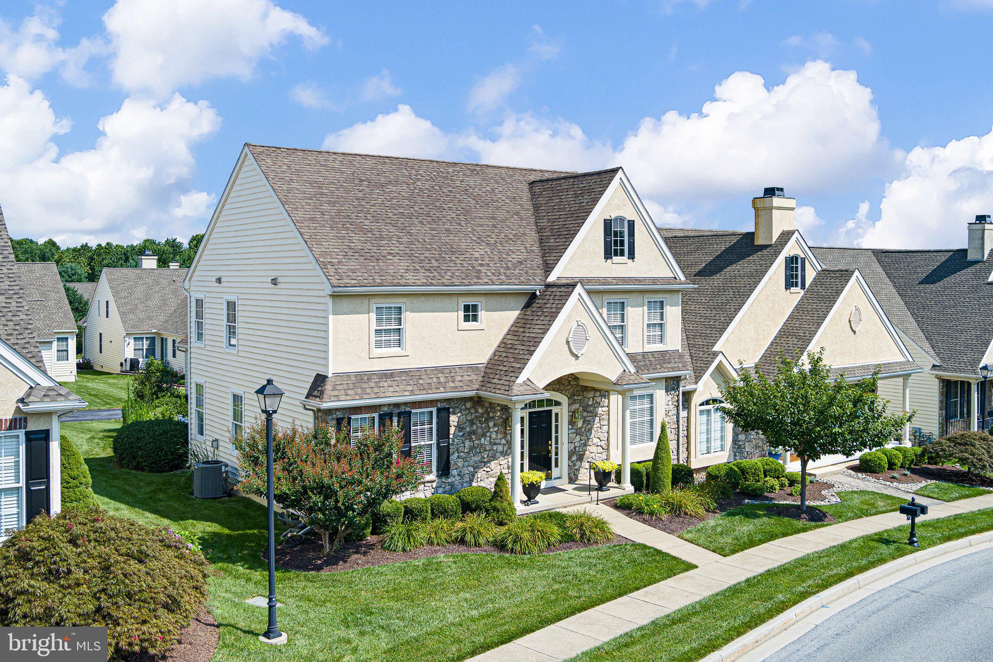 Welcome to this stunning 4-bedroom, 3 full bath Wilkson-built home in Brittany Hills in Avondale, PA, a 55+ community. Located near the PA-DE state line, the Burbury Traditional model is centrally located between Hockessin, DE and Kennett Square, PA, in close proximity to Winterthur Museum & Gardens, Longwood Gardens, and area shops and restaurants. The home offers 2,826 of finished living with a 2-car garage and unfinished full basement. Situated on 0.15 acres, one can enjoy the community and rolling hills of Pennsylvania while caring for a small garden, if desired.
The front porch and oversized front door welcomes family and friends into the gorgeous two-story foyer with its grand staircase. Turn right and step into a spacious dining room or left to a full first-floor bath next to a first-floor bedroom. Walk forward to the open-concept layout with a family room, kitchen, and breakfast room. Enjoy cool nights in front of the gas fireplace or step out through double French doors onto a private deck to enjoy morning coffee or to grill for company.
The kitchen features 42” cherry wood cabinets, an island with seating under a chandelier, granite countertops, tumbled marble backsplash, and stainless-steel appliances including double wall ovens, refrigerator, dishwasher, built-in microwave and a gas cooktop. A perfect setting and space for everyone to gather.
The primary suite is amazing!. Enter through a relaxing sitting room to the large bedroom area with an abundance of natural light. The primary bath features two vanity stations with a dressing area in between, a walk-in shower, and water closet. Don’t miss the two large, walk-in closets! Two more bedrooms on the second floor share a full hath bath creating an inviting space for family and guests.
The basement is the full footprint of the home with opportunity to finish the space. Enter the 2-car garage from the rear lane and step into the laundry room that leads to the main living space on the first floor.
Other wonderful amenities include the hardwood floors, windows that draw in the natural light, tall ceilings, recessed lights, and lovely millwork throughout the home. Take advantage of the sidewalks, community clubhouse with its indoor pool, fitness center, library and meeting rooms, and outdoor pickleball courts plus a community garden. Don’t miss this immaculate, French-style home in the rolling hills of the Pennsylvania countryside. This home awaits its new owners!