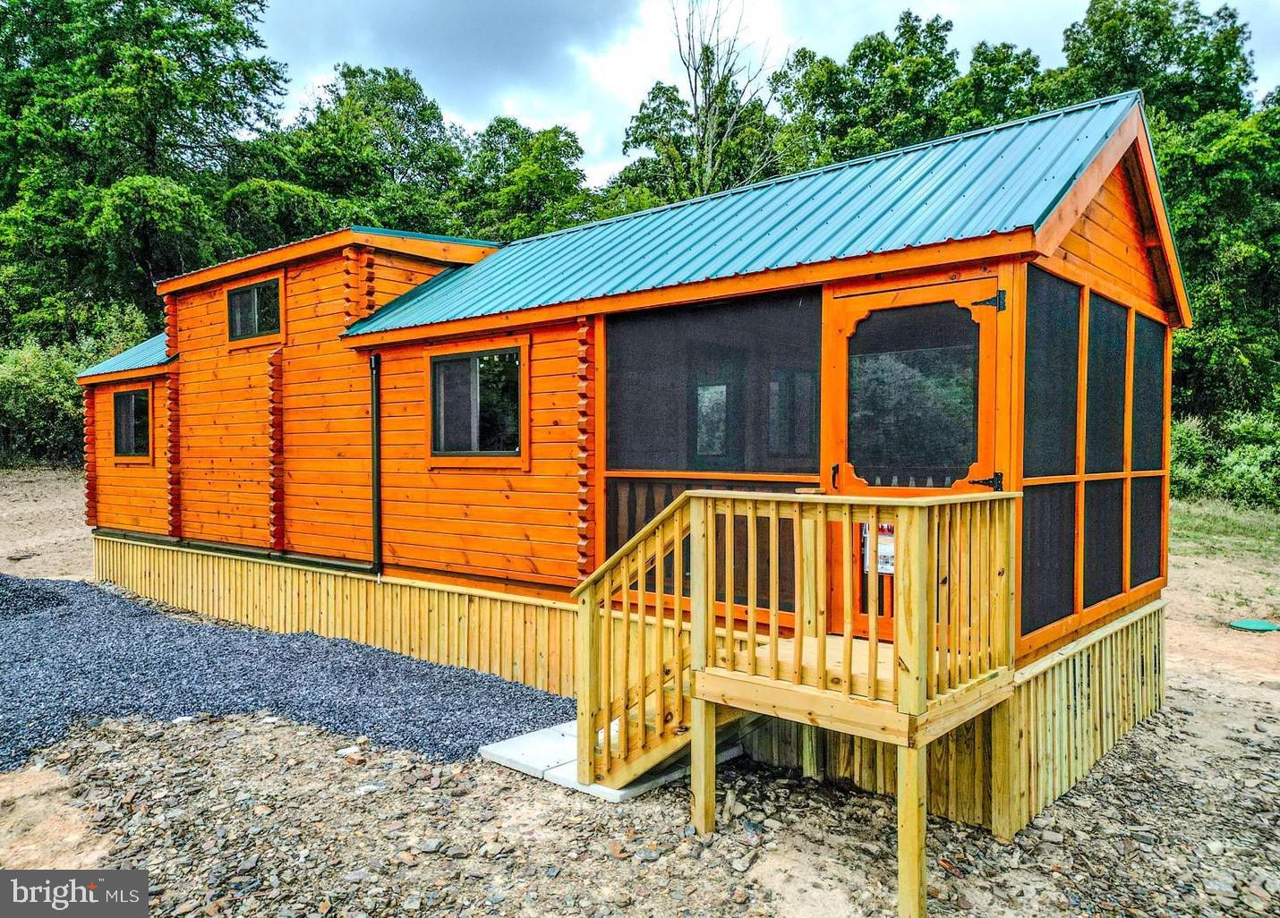 SELLER MOTIVIATED - BIG PRICE REDUCTION!! **Rustic Yet Contemporary Tiny Home Log Cabin in the Heart of the Appalachian Mountains** Discover the charm and freedom of living in a true log cabin nestled in the heart of the Appalachian Mountains. This property offers no HOAs to burden or infringe on your freedoms! Whether you're just starting out as a homeowner or considering a real estate investment, you can't go wrong with this delightful cabin. Owning this property is less expensive then current rental payments. Investors - the STR opportunities are endless here! Rustic Yet Contemporary Design! With functional use of space every inch of this cabin is designed with practicality in mind. Relax and enjoy the outdoors year-round in any weather on your spacious enclosed porch. The living area offers ample space for a comfortable retreat after a day of adventure. The fully functional Kitchen includes a breakfast bar for casual dining, all the necessary appliances for convenience with sufficient counter and cabinet space. Full sized bathroom equipped with all the essentials for everyday living. The Main Bedroom is 12x10 (approx) and can accommodate a king or queen bed with ease or 2 doubles. Washer/Dryer Hookups are included. There is a Computer/Desk/Storage Area that can easily accommodate bunk beds for additional sleeping arrangements if needed or be utilized as a pantry or large closet. The massive loft 11x17 (approx) provides space for two queen mattresses, perfect for guests or extra family members. Mini Split Heat/AC for efficient heating and cooling for year-round comfort that is reliable and convenient. Metal roof with gutters and downspouts to keep the cabin well-maintained. Hassle free public water supply. All situated on an easily maintainable 1.35 acre lot located perfectly near all that West Virginia has to offer, including skiing, fishing, boating, hunting and hiking. Just minutes off Corridor H/US 48 and close to popular attractions such as Seneca Rocks, Davis/Thomas, Spruce Knob, Vepco Lake, Potomac River, Canaan Valley Ski resorts and Blackwater Falls. This delightful, affordable, and sensible investment is perfect for anyone looking to embrace the Appalachian lifestyle. Don't miss out on the opportunity to own a piece of mountain paradise before it's gone!!!