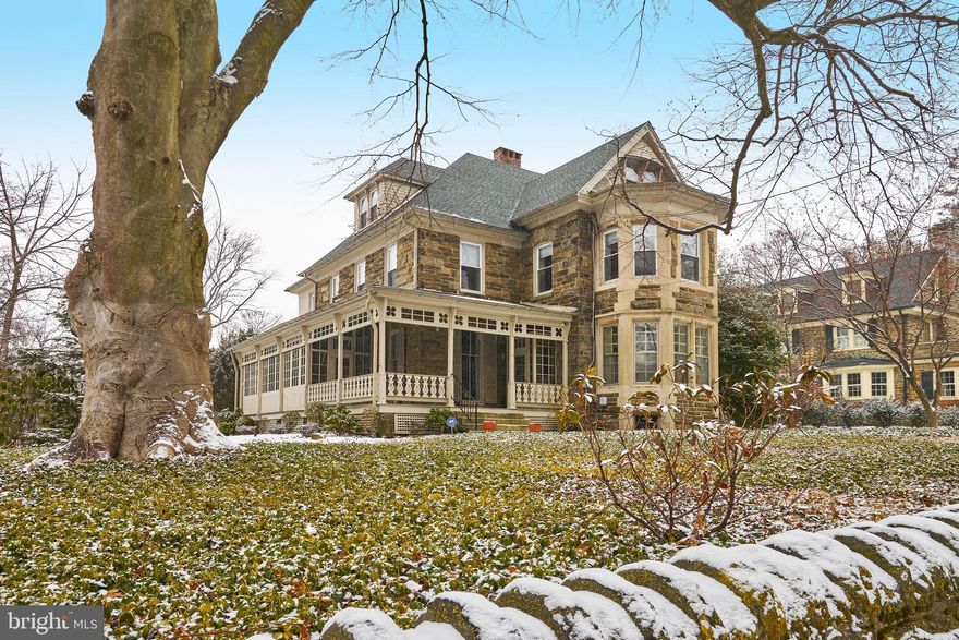 Move right into this beautifully renovated, stately Victorian with wrap around porch, perched above West Chestnut Hill Avenue just a block from the trailheads of Fairmount Park. The houses lining this street were designed by some of Philadelphia’s finest residential architects, and 115 is no exception. Designed by William H. Decker in 1888, this home features sensitive upgrades coupled with the original architectural details, such as coffered ceilings, crown molding, gleaming inlaid hardwood floors, deep windowsills, stained glass windows, Mercer tiles and more. Enter through the French doors with filigree wrought ironwork, to the sunlit parlor with the main staircase, fabulous parquet floors, coffered ceiling, wood-burning fireplace with carved mantle and antique hand-blown glass chandelier. The dining room features a fireplace with original tile, and adjacent custom butler’s pantry with 2 beverage fridges. The living room, currently used as a billiards room, features the original decorative plaster ceilings, and floor to ceiling windows that open to the wrap-around porch. The spacious kitchen offers custom cabinetry, breakfast area, 8-burner Wolf range, Sub-Zero fridge, honed granite and quartzite counters, brick backsplash with Mercer tiles, rear staircase and powder room. On the second floor, the primary bedroom suite offers a marble fireplace with delft tiles, walk-in closet and sunlit bath with soaking tub, and walk-in marble shower. The second bedroom, currently being used as an office, has two closets and access to the full hall bath. A sitting room with fireplace (or additional bedroom), hall closet and laundry room complete the second floor. The third floor offers an additional three bedrooms, each with ample closet space, and a full hall bath. The wrap-around porch is partially enclosed as a sunroom, and will become a favorite spot to relax on warm weather evenings. This immaculate home is in a prime location, just a few blocks from the fantastic shopping and dining in Chestnut Hill, the recreation of Fairmount Park, and both the Chestnut Hill East and West Train Stations, for an easy commute into the city. Don’t miss this gem!