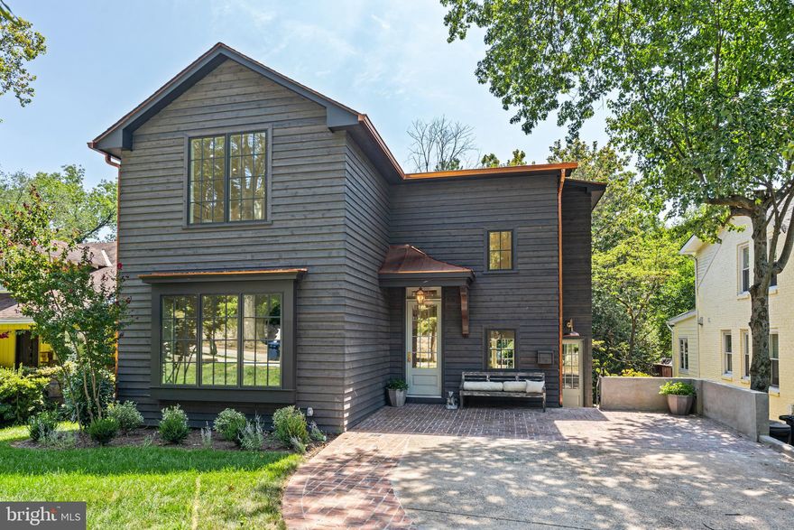 ** So special it was named the Wash. Post HOUSE of the WEEK**  Nestled on a deep and grassy lot in the desirable and welcoming Kent neighborhood in Northwest DC, this home has been meticulously renovated with no detail overlooked by local, boutique developer Scribe Development.  Scribe's hallmark is to renovate and reimagine homes with the utmost care & attention to detail.

This delightful 'Mountain Retreat in the City' finds natural inspiration from the southern Appalachian mountains and the architecture of the shingled homes and cottages in Highlands, North Carolina. The exterior is a natural western red cedar lap siding with mitered outside corners  with copper accents and details, and the casement windows are in a rich, iron ore finish. The existing brick driveway is enhanced with red brick in a basketweave pattern providing additional texture and patina; and a custom, built-in EV charger has been installed.

The welcoming exterior portico flows into a breathtaking two-story foyer, vaulted ceilings, white oak floors, an open staircase in white oak with candlestick balusters, and strategically installed lighting to showcase an owner's art collection. The main floor formal entertaining spaces include a light-filled yet intimate front room for both casual supper and formal dinner parties -- or use as an office or family room -- and a richly decorated sitting room with custom built-in cabinetry, Farrow & Ball paint and hand made brass lighting.  Bespoke touches are seen and felt at every turn: custom moldings and casements, the hand-hewn details, custom-crafted lighting, and built-in shelves and niches.

The hall from the foyer leads to the heart of the home -- an open-concept kitchen and dining / family room with selections that reflect a nod to nature: a white oak island, honed Taj Mahal quartzite countertops and floating quartzite shelving.  From the kitchen, the large window & french doors provide long-range views of the lush, deep rear yard. The large island with ample seating opens perfectly to the family room with an inviting fireplace with a slate surround and custom-crafted bookshelves.  It flows nicely out to a deck for dining and a breezy and welcoming screened-in porch that provides additional year-round living space -- ideal for al fresco dining, entertaining and relaxing.

Just off the brick driveway there is also an informal side entrance with a whimsical built-in herb garden that leads to a charming and functional space with custom-tiled terra cotta porcelain floors and shiplap walls -- and a beautiful granite prep sink, custom-built cabinetry, separate mudroom, and two large pantry closets.

The second floor has a gracious open foyer -- all with impressively high ceilings there are three nicely sized bedrooms, one with an en suite full bath with cornflower blue penny tile; a  full hall bath with white quartzite and white carrara marble and a stackable washer/dryer. Step into a world away into the hallway of the private primary retreat boasting a massive custom walk-in closet; a full bath with double sinks; honed carrara and allure gray marble checkerboard floors; herringbone shower; and the tranquil bedroom with vaulted ceilings and treetop vistas.

As you make your way to the lower level, there is a charming wallpapered powder room for guests -- then on to the windowed walkout lower level with a bedroom and bathroom and an oversized shower just perfect for guests, in laws or an au pair.  Enjoy a dedicated gym/Peloton room or office and a large family room that's perfect for movie night or the big game with doors that lead out to even more entertaining space with another outdoor dining area and large bluestone patio ideal for a firepit, conversation and enjoying nature.  There is  walk-in laundry with energy efficient machines, storage and a sink and a custom storage room with lighting and shelving for bikes, tools, & more.

NEW DRAFT RENDERING of how an in-ground pool would look --  stunning!