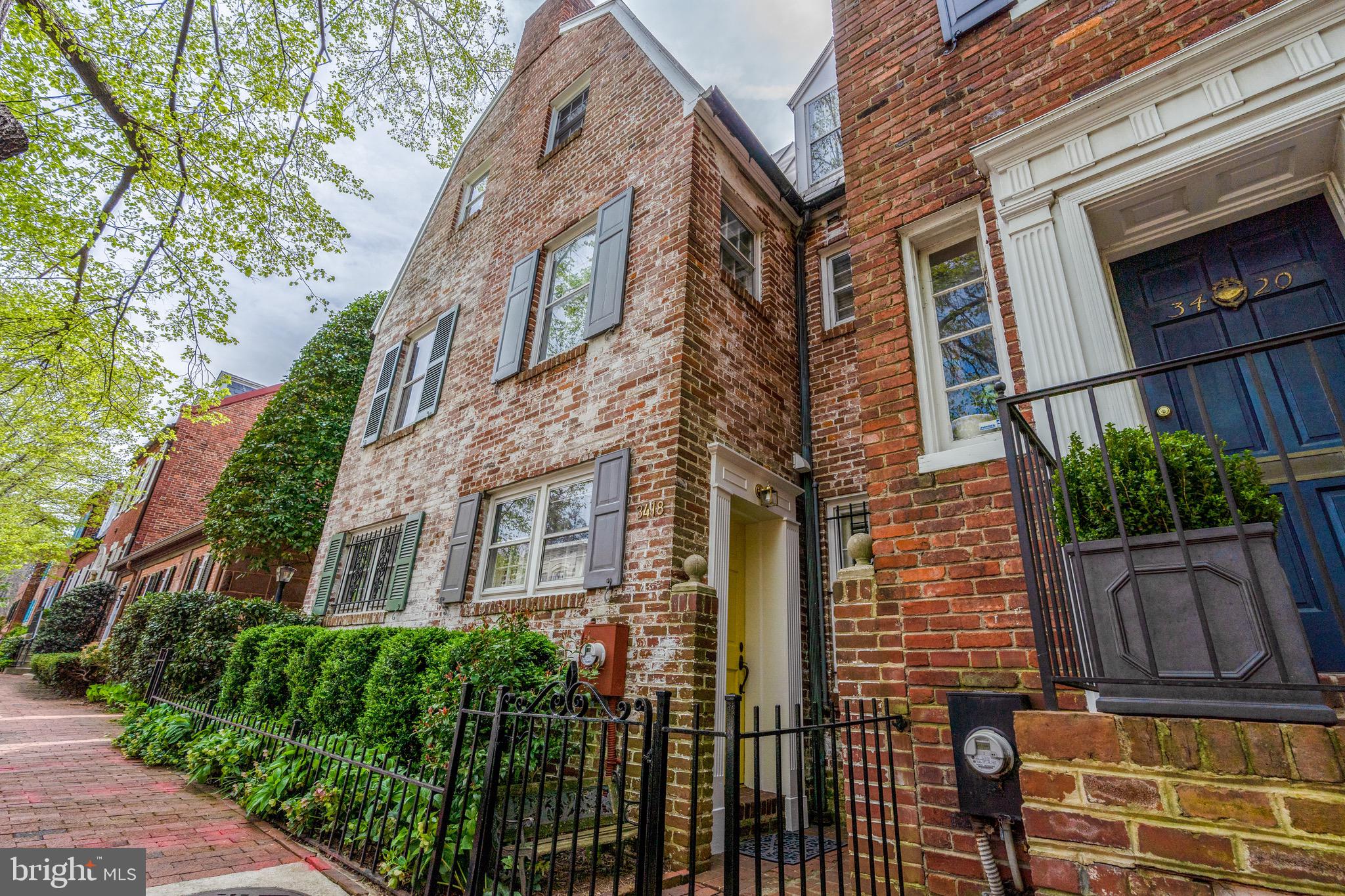 Fantastic New Listing in Georgetown!
Charming & sunny three story Federal-style residence with three bedrooms, two full bathrooms plus a powder room in approximately 1500 square feet of living space.
Serene and peaceful south-facing garden patio. Upon entering this lovely home you discover a formal entry and a hallway leading to a formal dining room with views to the private garden and terrace. The kitchen boasts stainless steel appliances, an abundance of cupboards and counters. There is also a window in the kitchen looking out towards the front entrance and the brick sidewalk. Ascend the original staircase to the expansive living room with a wall of windows facing south and into the garden below, a wood-burning fireplace and a wall of built-in bookshelves. The hardwood floors are lustrous and in terrific condition. There is a guest bedroom with en suite bath on this level as well. This room could also be used as a den. The uppermost level of this residence features a primary suite and a transitional room which could be restored to a third bedroom or used as an open loft for a multitude of uses. New copper roof installed in 2020, two new HVAC systems in 2013, renovated bathrooms in 2013. There is also an attic for storage, a coat closet on the first floor, a garden bench with storage and a storage shed for garden tools. The house is steps away to Volta Park which boasts tennis courts and a swimming pool. Wisconsin Avenue and M Streets are mere blocks away. Enjoy world-class dining and a plethora of shops and boutiques. Safeway, Trader Joe’s and Whole Foods grocery stores are also blocks away. Metro bus and Metro rail are easily accessible from this residence. Rock Creek Park and Parkway are also within close range.