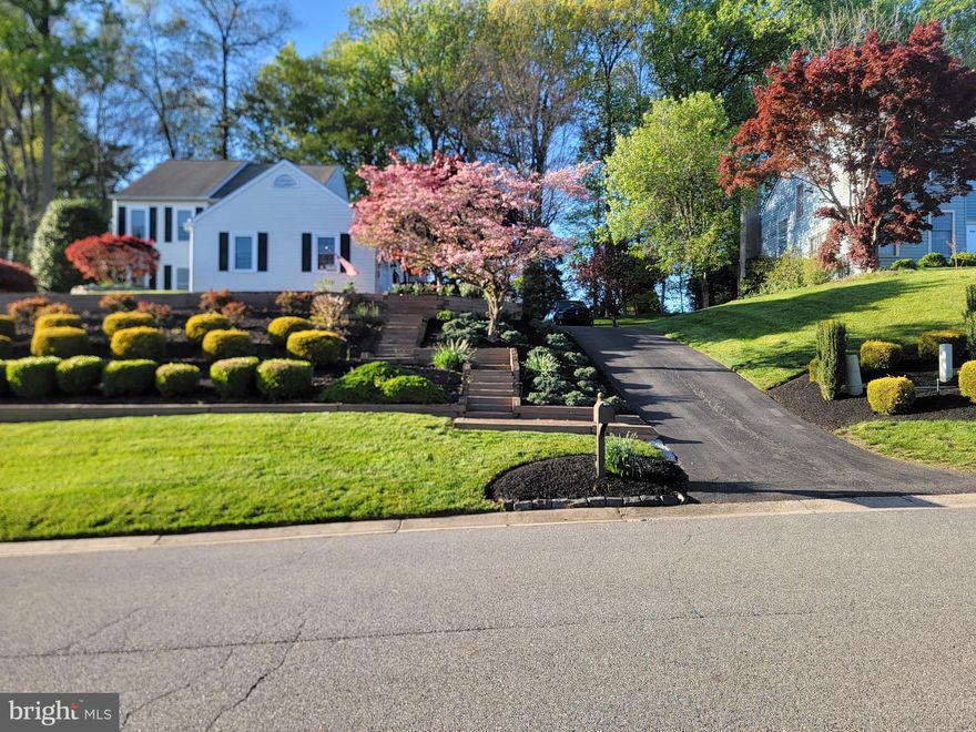 Welcome to 58 Willow Creek Lane, a charming home in the sought-after Chestnut Valley community, a rare find in this desirable area. Located in the popular Pike Creek area, this home offers easy access to shopping, major roadways, and more. This four-bedroom, two-and-a-half-bathroom home features a full, unfinished basement, a side-entry two-car garage (and side entry driveway for room to turn around), and a host of recent updates. As you approach the home, you'll immediately appreciate the stunning landscaping and hardscaping that surrounds the entire property. A custom paver stone walkway and staircase leads from the bottom of the driveway to the front door and continues around the home. At the back, a large Trex deck and paver stone patio off the kitchen provide a perfect spot to relax, shaded for year-round enjoyment, with a serene view of the tree-lined backyard. Upon entering, you're greeted by beautiful hardwood floors and crown molding that run throughout the main level. To the left is the family room, filled with natural light from its large windows. On the right, the living room boasts a vaulted ceiling, two skylights, and a gas fireplace with a marble surround, wood framing, and a mantel. The kitchen is a standout, featuring updated granite countertops, stainless steel appliances, gas cooking, a slate grey subway tile backsplash, custom cabinetry, and an eat-in breakfast nook. A formal dining room is conveniently located just off the kitchen, along with a double-door coat closet and a fully updated half bath. Upstairs, you'll find four spacious bedrooms, two beautifully renovated bathrooms, and a convenient laundry room. The primary bedroom offers a walk-in closet and an impressive two-story ceiling, with a staircase leading to a finished loft that can serve many purposes, along with walk-in attic space for extra storage. The updated primary bathroom features farmhouse-style wood-look tile, a new vanity, a new toilet, and a custom-tiled walk-in shower with a frameless glass door. The hall bathroom is equally well-appointed with the same wood-look tile, a new vanity, new toilet, and a newly tiled tub/shower with a glass door. The unfinished basement presents great potential for future expansion, and with the HVAC system, air conditioning, water heater, and roof all replaced just 11 years ago, you can rest assured the home is in excellent condition. With meticulous care both inside and out, this home is ready for its next owners. Schedule your showing today and move in just in time to enjoy the warmer months ahead!
