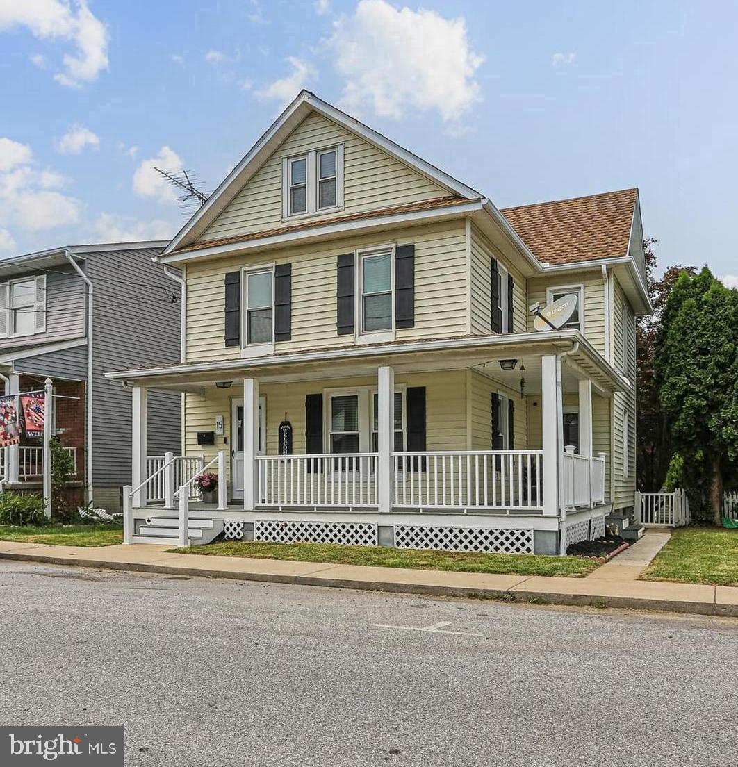 Welcome to 15 Hersh Avenue, where old-world charm meets modern conveniences with an abundance of upgrades (and the home can convey fully furnished if desired)!! From the moment you arrive, you'll be greeted by an inviting covered wrap-around porch, complete with low-maintenance composite rails, offering an ideal space for enjoying quiet summer evenings. This home has been thoughtfully updated with numerous significant updates including: a tank-less water heater, a high-efficiency gas furnace, and an AC compressor, all installed in 2022, as well as updated electric service, replacement windows, updated plumbing, and a newer roof. This property truly offers a nearly maintenance-free home! Step inside to discover beautifully preserved original hardwood flooring (refinished several years ago) and elegant trim work that immediately capture your attention. The main level features a stylishly updated kitchen equipped with stainless steel appliances and freshly painted cabinets, along with a newly installed full bathroom, also completed in 2022. Adjacent to the kitchen is a formal dining room, currently utilized as a bedroom with a separate side exterior entrance, offering flexible living arrangements that can easily be adapted back to a dining space. Just off the kitchen, a delightful sunroom provides a perfect setting for private gatherings, overlooking a fully fenced-in, flat backyard enhanced with a privacy fence. Venture to the second level, where you will find three bedrooms, each boasting original hardwood floors, and a tastefully updated full bathroom. Continuing up to the recently finished attic space reveals an additional bedroom featuring a convenient walk-in closet. Parking is ample and convenient, with paved parking allowing for 3 spaces for cars plus a one-car detached garage. This property's prime location is just minutes from McDaniel College, presenting an excellent investment opportunity for rental to students or staff. It is also centrally located to numerous restaurants and shops on Main St, as well as commuter routes. Endless possibilities await! *Please view 360 Photo Tour*