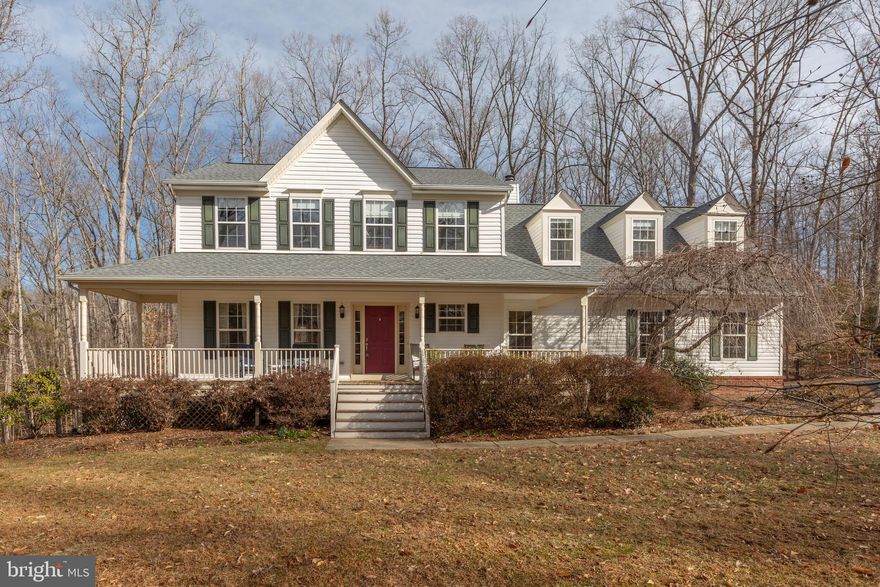 BEST OF BOTH WORLDS! 3 Peaceful Wooded Acres of Privacy and EASY ACCESS to Shopping & Transportation! UPDATED AND UPGRADED! This Beautiful 4-bedroom Piccard Colonial is MOVE-IN READY, and features a welcoming Front Porch, Side Load Garage with Extended Driveway and Exceptional Upgrades Throughout - including a Recent Roof!  Beautiful contemporary LVP Flooring spans both the main and upper levels! Thoughtfully designed living spaces make every room inviting as you enjoy woodland views throughout the home! The Main Level includes a Living Room, Dining Room, Gourmet Eat-In Kitchen, Family Room, convenient Half Bathroom, and Laundry Area. The Stylish and Functional Kitchen has been upgraded, boasting additional Cabinetry for ample Storage, Granite Countertops, Stainless Steel Appliances, and more! Off the Kitchen is the Family Room featuring a charming Fireplace and Built-in Bookcases, creating a perfect space for relaxation and gatherings. The upper level has 4 generously sized bedrooms and a versatile bonus area, perfect for a sitting nook, playroom, recreation space, hobby corner, etc. The spacious Primary En-Suite is a true retreat, featuring 2 closets and a Beautifully Renovated Bathroom complete with a double vanity, soaking tub, and a separate shower.  From the family room and kitchen step directly out to a Tiered Deck with stairs to your own Private Backyard Oasis.  The backyard offers open green space and a tranquil wooded backdrop, creating the perfect setting for relaxation, entertaining, and enjoying nature. The walk-out finished basement is a versatile space featuring a recreation area, a half bathroom, ample storage, and more—perfect for entertaining, a home gym, or a guest suite!  Make an appointment to see this home today!