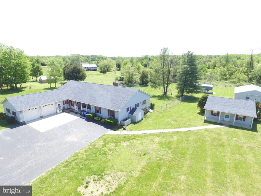 Immaculate Rambler on Large Level Lot.  This home features beautiful hardwood floors, a wrap around sun-room with ceramic tile, a huge country kitchen, Rear Deck, Fenced Back Yard, Two car Attached Garage, Huge Detached Storage building with electric , Separate Detached In-Law Suite and the list goes on and on.  No HOA!  Great Commuting location.   Lots of room for a growing family.  Eligable for 100% financing thru USDA Rural Development (If Qualified).