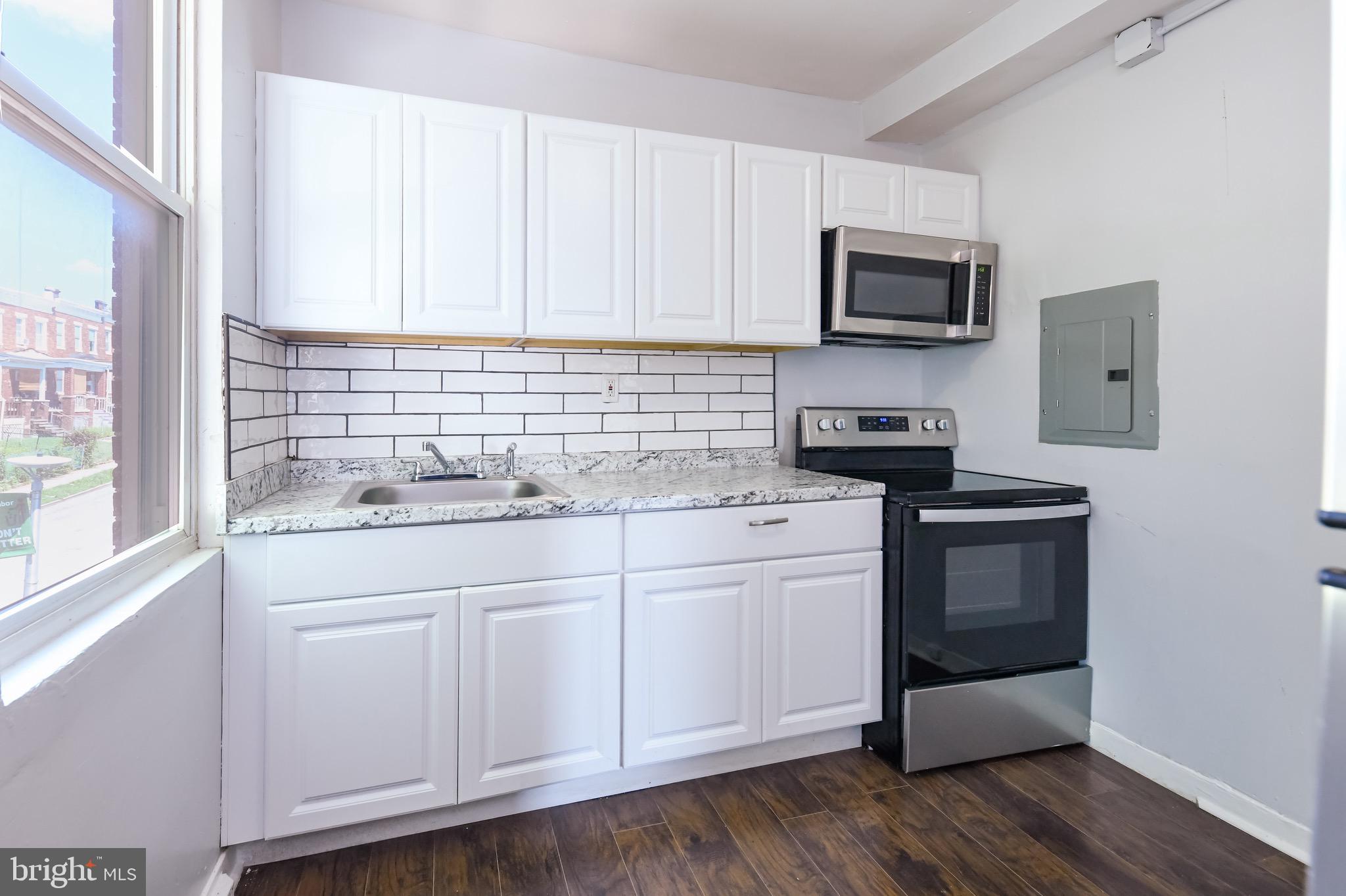 Welcome to this spacious 3-bedroom, 1-bath apartment located on the second floor of a well-maintained duplex. This freshly updated unit features modern vinyl plank flooring throughout, large windows that fill the space with natural light, and a smart layout designed for everyday comfort.
The kitchen is outfitted with white cabinetry, a sleek range and built-in microwave, and a clean subway tile backsplash. The bathroom offers a large walk-in shower and updated finishes. Each bedroom provides good closet space and contemporary lighting.
Enjoy the comfort of central air conditioning, and rest easy knowing that water is included in the rent.
Situated along Edmondson Avenue, this home offers easy access to public transportation, local shops, and nearby parks. It’s conveniently located near major commuter routes, making it a practical choice for those on the go. Schedule your tour today.