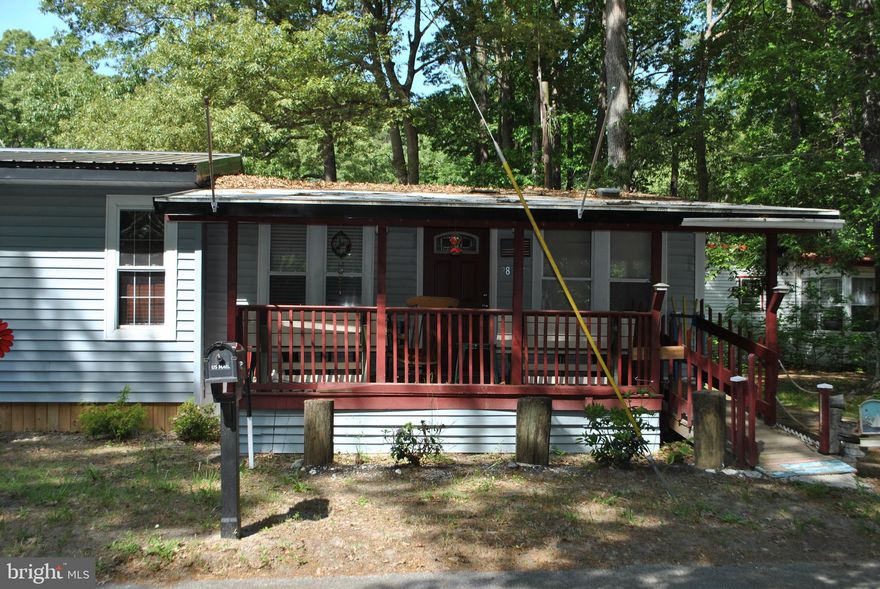 Affordable living near the water. This cottage sits on an extremely large lot and has a recently added
master bedroom and closet!  The covered front porch and screened in back porch add lots of extra living space. The kitchen is open to the living area and back porch, which provides easy access to both.  There are
two extra bedrooms and a full bath with plenty of sleeping area.  The exterior has a fire pit area, two  sheds for storage and a fish cleaning area in between.   There is also a covered structure big enough to store a large boat.  The home comes fully furnished and the new buyers must be park approved.  The private boat club is just blocks away and with easy access to the Indian River Bay.   So grab your fishing rods, put on your party hat or just relax, but don't wait to long to own this great property!