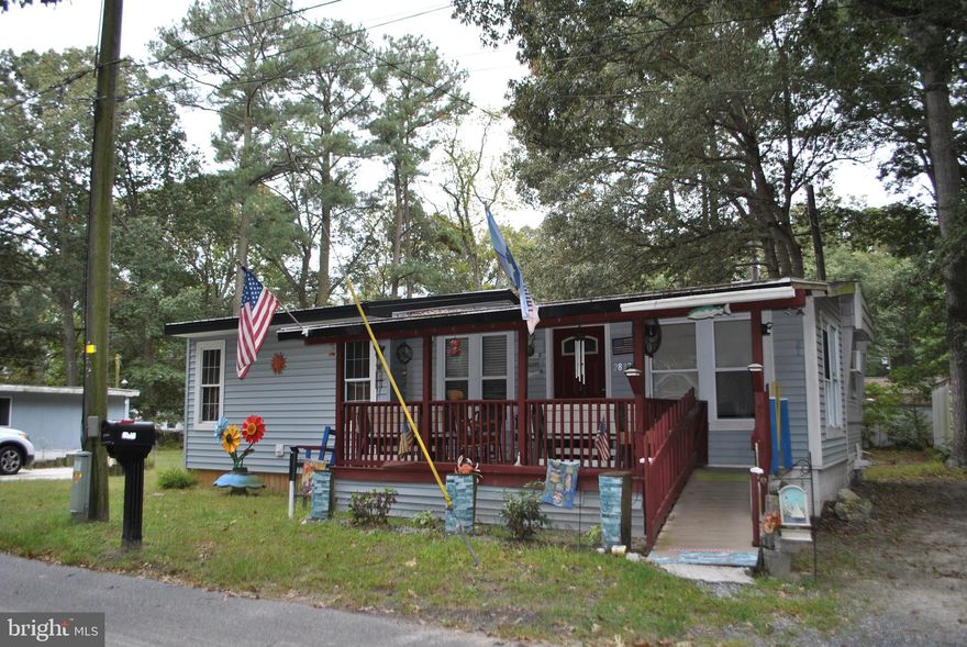 Affordable living near the water. This cottage sits on an extremely large lot and has a recently added
master bedroom and closet!  The covered front porch and screened in back porch add lots of extra living space. The kitchen is open to the living area and back porch, which provides easy access to both.  There are
two extra bedrooms and a full bath with plenty of sleeping area.  The exterior has a fire pit area, two  sheds for storage and a fish cleaning area in between.   There is also a covered structure big enough to store a large boat.  The home comes fully furnished and the new buyers must be park approved.  The private boat club is just blocks away and with easy access to the Indian River Bay.   So grab your fishing rods, put on your party hat or just relax, but don't wait to long to own this great property!