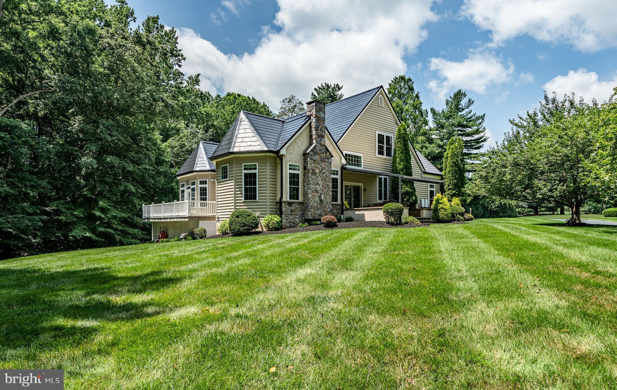 This stunning custom-designed home offers approximately 5,000 square feet of luxury, comfort, and exceptional upgrades. An incredible **ALL NEW SOLAR TILE** roof & gutters & fixtures just installed (over $375,000 cost) the remainder will be paid at settlement, no lease involved!! This makes your utility bill around $10 per month!! From the moment you enter, you'll be impressed by the elegant tile inlay and rich Brazilian cherry hardwood floors. Impeccably maintained & upgraded, this home showcases all new paint & hardwood floors w. 10-foot ceilings, tray ceilings, crown molding, chair rail, upgraded interior doors and windows, custom blinds , upgraded lighting and chandeliers throughout. Designed for both comfort and functionality, this home features a whole-house generator and a 3-zone HVAC system. Stucco was inspected in 2022 repairs made at that time. The spacious, open-concept layout includes a sunlit living room, dining area, and a large open kitchen equipped with upgraded cabinetry, granite countertops, tile backsplash, stainless steel appliances, gas cooktop, built wall oven/ microwave, & oversized island. Eat in kitchen area with a cathedral ceiling and a picture window sits just above sliding glass doors that open to a peaceful side patio and private backyard. The adjacent family room boasts a cozy gas fireplace and a French door leading to the rear deck. Off the main living space is a beautifully crafted library with custom cherry built-ins, a beverage fridge, and large windows overlooking the back deck. The luxurious main-level primary suite features *NEW* hardwood floors a tray ceiling with fan, a full wall of windows with deck access, two spacious walk-in closets, and a spa-like en suite bath complete with double cherry vanity, soaking tub with tile surround, and a walk-in tile shower. A *second* bedroom suite on the main floor offers a tray ceiling, large walk-in closet, and a private bath with a tub/shower and beadboard wainscoting. Additional features on the main floor include a stylish powder room and a generous laundry/mudroom with tile flooring, cabinet sink, extra storage, and garage access. Upstairs, a spacious loft overlooks the main living area and provides access to a large storage closet with an enclosed cedar space. The third and fourth bedrooms each feature ceiling fans and large walk-in closets, while a full bath with tile surround serves this level. The finished lower level includes a new water heater, dedicated home gym with rubber flooring and a full bathroom featuring subway tile and an oversized walk-in shower with a bench. A wine room with stone tile flooring, a large storage/workshop area with built-in shelving, and a vast unfinished media space with sliding doors to a side patio complete the basement. Above the garage, a private office with a full bathroom and separate entrance provides a perfect work-from-home setup or guest suite. Located on a secluded lot in an award-winning school district, with no HOA's this exquisite home offers timeless style, thoughtful design, and unmatched comfort. Schedule your private showing today of this low cost to maintain large executive home in Garnet Valley. See utility bill, solar information and floor plans, all in attachments. Check out video tour as well!