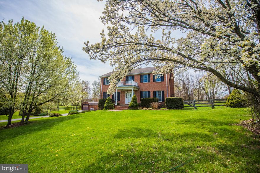 Traditional brick colonial on well maintained 2 acre lot partially fenced. Spacious rooms, some with hardwood floors.  Family room with fireplace and gas logs. Master bedroom with 2 large walk-in closets & full bath. 2 car garage in basement plus unfinished space.  Detached 12 x 24 building.  Large rear screened porch. Koi Pond, established fruit trees, wooded parklike back yard.  Great location!!