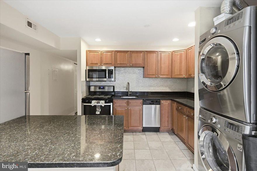 Now offered at $145,000, 8459 Greenbelt Rd #T-1 presents one of the best values in Greenbelt for a one-bedroom condo featuring in-unit laundry and included utilities. The home is spacious, move-in ready, and centrally located with convenient access to MD, DC, VA, and Baltimore. The updated kitchen features granite countertops, stainless steel appliances, and ample cabinet space, flowing into a bright open living area filled with natural light and access to a private patio ideal for relaxing or entertaining. The generous bedroom provides excellent storage, and the in-unit washer and dryer add everyday convenience. The condo fee includes electric, gas, water, parking, and community amenities, helping keep monthly costs predictable and low. A 1-year home warranty is included for added peace of mind. Being sold as-is, this property presents an excellent opportunity for first-time buyers, downsizers, or investors seeking strong value in a commuter-friendly location. Seller is motivated ready to move forward and carefully consider all reasonable offers.