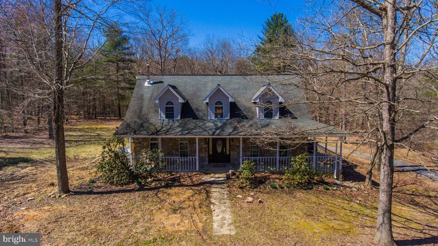 PRICE REDUCED, MOTIVATED SELLLER!  This cape cod is a country charmer with great curb appeal and an abundance of potential at an amazing value for the square footage and private acreage.  Set on an acre and a half of land, the property features a wrap around porch, rear patio, carport and shed, but this home revolves around the huge country kitchen which adjoins the formal dining room and walks out to the patio.  It features a commercial grade gas oven and range, a sprawling island with bar seating, and really is a baker's kitchen with enough counter space to cook all day.  Low maintenance hardwood, vinyl, and tile flooring runs through most of the main floor living spaces.  Upstairs you will find a master suite big enough to get lost in, his and hers walk-in closets, an updated master bathroom, a spacious sitting room, and a personal balcony overlooking the property.  Two more bedrooms upstairs and a fourth bedroom on the main floor join two full baths, one on each floor.  There really is enough space for entertaining guests of all occasions.  A negotiable flooring allowance is being offered from the sellers in consideration of its condition.