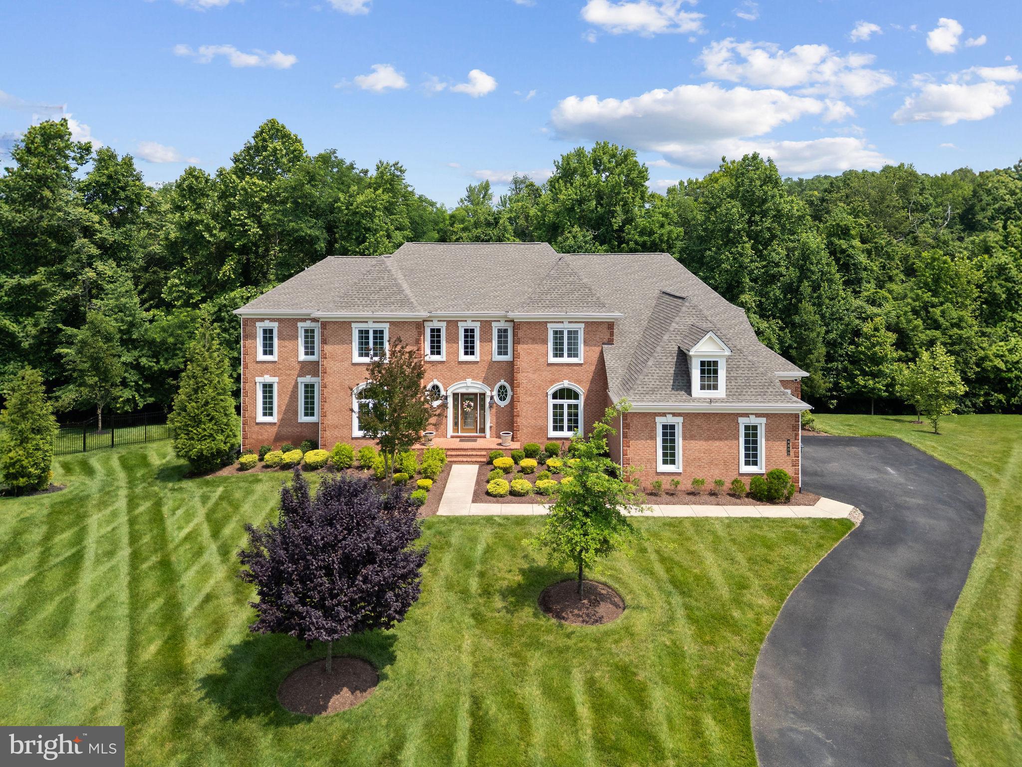Price Reduced!! Luxury and opulence await you in Prince Georges County’s highly sought after Marlboro Ridge Estates. This elegant, 10,000+ square foot Estate home was built by Toll Brothers, America’s luxury home builder, with many custom features and improvements. 4400 Palomino Crossing is a spacious and beautiful home for the discerning buyer who deserves one of the premier offerings currently in Prince Georges County, Maryland. Luxury begins at the end of a cul-de-sac of Estate homes. The instant curb appeal of beautiful brick façade, lush mature landscaping, manicured lawn, thoughtfully designed hardscape, spacious driveway and custom lighting offer a warm welcome. Once inside, you are greeted by an impressive, two story, double staircase in the grand foyer. Beautiful hard wood floors lead to a large formal dining room and formal living room. A spacious, step-down conservatory is accessed from the living room. Enter the private office through double French doors for a spacious, naturally well-lit space to conduct your business. A convenient half bath is steps away. Double coat closets offer ample space for guests coats and storage. Enter the gourmet kitchen which features a large center island with under counter seating space perfect for food presentations and entertainment. Triple Monogram ovens, cook top and custom Viking bread warmer are a chef’s delight. Ample custom cabinets are basked in the glow of gorgeous overhead and drop lighting fixtures. The adjacent inviting sunroom offers warm, natural light for relaxing and entertaining. High-top bar seating allows you to unwind and witness the chef at work. From the kitchen, you’ll access an additional 800+ square feet of outdoor living space complete with a deck and a gazebo that features recessed lighting, a large ceiling fan, and a motorized, retractable screen. Back inside and through the kitchen, this level is completed by a functional mudroom with bench seating and a conveniently placed additional half bath- just one of the custom features of the home. From the mudroom, you can access the four-car garage and storage space. The upper living area can be accessed by both the main staircases and from a rear, single staircase. Once upstairs you’ll overlook the grand foyer, the owner’s primary suite, and three additional bedrooms, all of which have full baths. Two of the bedrooms also enjoy cozy sitting rooms. The convenient laundry room is appointed with a Whirlpool washer and dryer. Enter the massive en-suite primary bedroom through stately double doors where total rest and relaxation await. The suite includes a luxurious spa bathroom featuring a large soaking tub, walk-in shower, dual vanities, and dual water closets for extra privacy. A custom linen closet completes this stunning bathroom. An expansive, walk-in closet provides more than ample space for dressing and storage. Make your way to the basement by descending from any of the three stairways and entering through a door adjacent to the kitchen. Welcome to an open entertainment paradise lounge area perfect for family gatherings, memory making moments and fun entertainment. This comfortable space features a custom wet bar that seats eight. A few steps away and you are in the grand theater for cozy movie nights. Bedrooms five and six complete this expansive level. Exit through French doors to the lower level, hardscape patio. This magnificent estate has been impeccably maintained and exquisitely decorated. It features an in-ground sprinkler system and Generac generator. The home has been gently used and tours like a new home. It’s a short distance to major transportation routes and is centrally located near Washington, DC., Annapolis, Maryland, and Northern Virginia. It offers convenient access to local airports and U MD Med. Cntr. This masterpiece of a home is available for viewing NOW! This impressive luxury home won't last long -it's truly one of a kind!