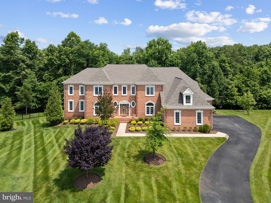 Price Reduced!! Luxury and opulence await you in Prince Georges County’s highly sought after Marlboro Ridge Estates.  This elegant, 10,000+ square foot Estate home was built by Toll Brothers, America’s luxury home builder, with many custom features and improvements.  4400 Palomino Crossing is a spacious and beautiful home for the discerning buyer who deserves one of the premier offerings currently in Prince Georges County, Maryland.  Luxury begins at the end of a cul-de-sac of Estate homes.  The instant curb appeal of beautiful brick façade, lush mature landscaping, manicured lawn, thoughtfully designed hardscape, spacious driveway and custom lighting offer a warm welcome.  Once inside, you are greeted by an impressive, two story, double staircase in the grand foyer.  Beautiful hard wood floors lead to a large formal dining room and formal living room.  A spacious, step-down conservatory is accessed from the living room. Enter the private office through double French doors for a spacious, naturally well-lit space to conduct your business.  A convenient half bath is steps away.  Double coat closets offer ample space for guests coats and storage.  Enter the gourmet kitchen which features a large center island with under counter seating space perfect for food presentations and entertainment.  Triple Monogram ovens, cook top and custom Viking bread warmer are a chef’s delight. Ample custom cabinets are basked in the glow of gorgeous overhead and drop lighting fixtures.  The adjacent inviting sunroom offers warm, natural light for relaxing and entertaining.  High-top bar seating allows you to unwind and witness the chef at work.  From the kitchen, you’ll access an additional 800+ square feet of outdoor living space complete with a deck and a gazebo that features recessed lighting, a large ceiling fan, and a motorized, retractable screen. Back inside and through the kitchen, this level is completed by a functional mudroom with bench seating and a conveniently placed additional half bath- just one of the custom features of the home.  From the mudroom, you can access the four-car garage and storage space.  The upper living area can be accessed by both the main staircases and from a rear, single staircase.  Once upstairs you’ll overlook the grand foyer, the owner’s primary suite, and three additional bedrooms, all of which have full baths.  Two of the bedrooms also enjoy cozy sitting rooms.  The convenient laundry room is appointed with a Whirlpool washer and dryer.  Enter the massive en-suite primary bedroom through stately double doors where total rest and relaxation await.  The suite includes a luxurious spa bathroom featuring a large soaking tub, walk-in shower, dual vanities, and dual water closets for extra privacy.  A custom linen closet completes this stunning bathroom.  An expansive, walk-in closet provides more than ample space for dressing and storage.  Make your way to the basement by descending from any of the three stairways and entering through a door adjacent to the kitchen.  Welcome to an open entertainment paradise lounge area perfect for family gatherings, memory making moments and fun entertainment.  This comfortable space features a custom wet bar that seats eight.  A few steps away and you are in the grand theater for cozy movie nights.  Bedrooms five and six complete this expansive level.  Exit through French doors to the lower level, hardscape patio.  This magnificent estate has been impeccably maintained and exquisitely decorated. It features an in-ground sprinkler system and Generac generator.  The home has been gently used and tours like a new home. It’s a short distance to major transportation routes  and is centrally located near Washington, DC., Annapolis, Maryland, and Northern Virginia.  It offers convenient access to local airports and U MD Med. Cntr. This masterpiece of a home is available for viewing NOW!  This impressive luxury home won't last long -it's truly one of a kind!