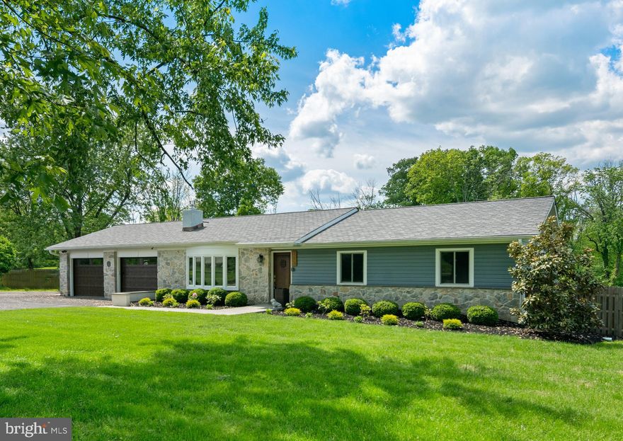 216 Brownsburg Road is ready to welcome you home! This fully renovated Ranch on over 5 acres is located right in the heart of desired Newtown. The home flows into an open-concept Gathering room, dining area, and kitchen. The Gathering room features a large bay window, recessed lighting, and a dramatic dry stack stone wall with electric fireplace. Hardwood floors connect the rooms while the kitchen and  dining area connect outdoors for alfresco dining. A new kitchen boasts stainless steel appliances, granite countertops, a center island with additional seating and convenient storage shelves, wood cabinetry, a Bosch wall oven and a Jenn-Air cooktop. The master bedroom is spacious and has three closets, one with custom built-in organizers, and the master bath is updated and modern, with a dual floating vanity with fish bowl sinks, a soaking tub, shower, and skylights. Two additional bedrooms have access to an updated full hall bath. A fully finished walk-up basement with an Anderson French door is the perfect space for entertaining, complete with a tiered home theater with built-in speakers and a drop screen, a custom wet bar with 2 wine refrigerators, and a half bath. The large, private fenced-in backyard provides plenty of outdoor space, along with a custom made Azek material deck with an outdoor kitchen, pizza oven, and built-in fire pit. Additional amenities include updated HVAC, new well pump, electrical panel, all LED lighting, wiring for internet extenders, surround sound in basement and living room, an abundance of large vehicle parking, and a 3 car attached garage and a 2 car detached garage, perfect for the car enthusiast or simply for additional storage. Great location close to shopping and dining, convenient for commuting, and in Council Rock schools.