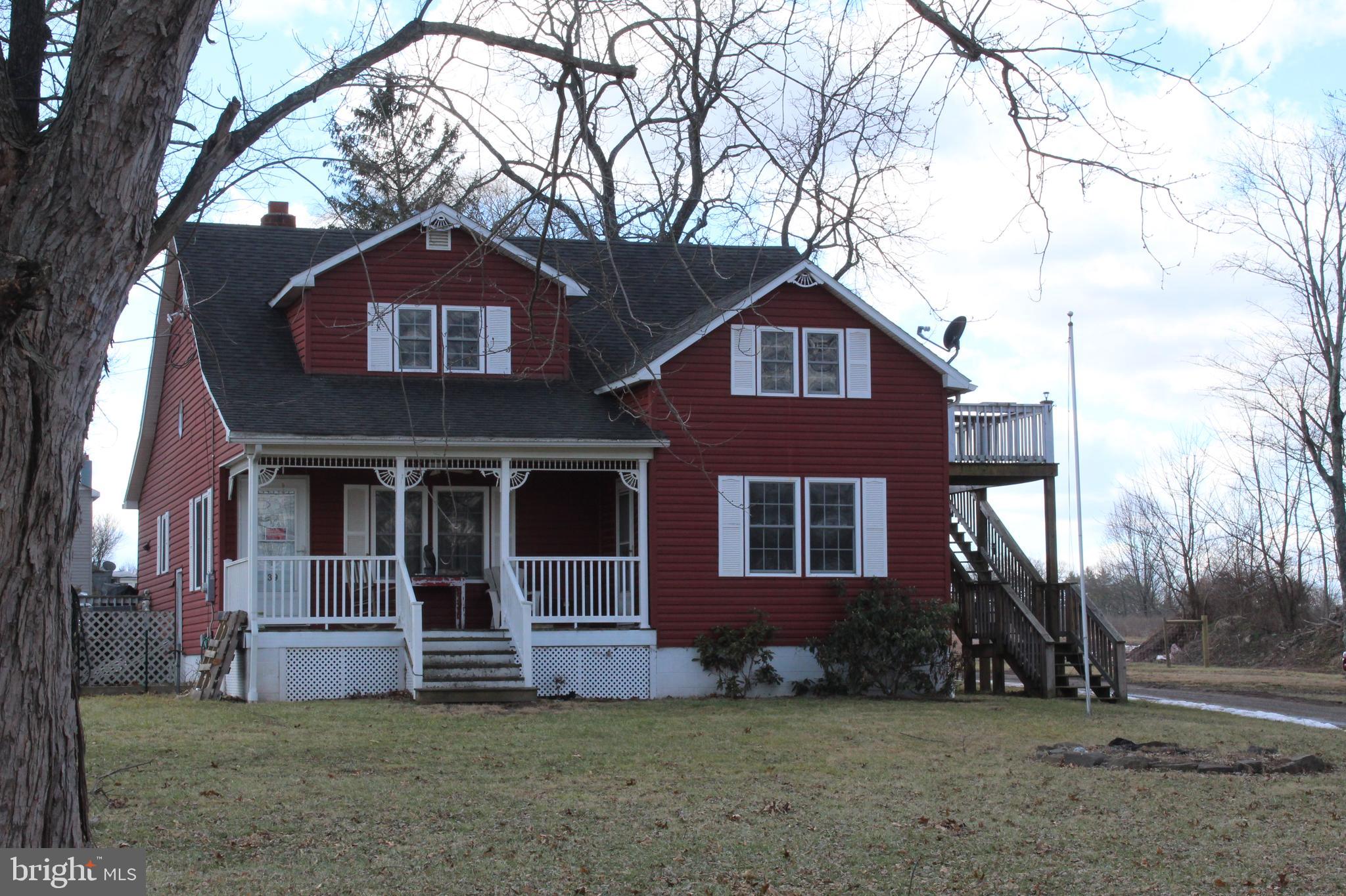 Nicely situated on 1.25 Acres towards the fenced rear of the property, covered front porch, large ground level deck, currently divided in to 2 units with separate stairs and entrance to upper apartment. 2nd kitchen in upper level, could easily unblock inside staircase to return to single family living. floored basement is great for storage and has side entrance from outside as well as inside stairs, lots of remodeling done (2007-2008). no restrictions, lots of frontage on Rt 50 , great road side stand location