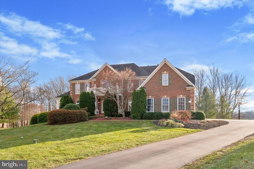 Welcome to 11 Edmondson Drive, an exceptional home nestled in the prestigious Olmsted Community, within the highly sought-after Unionville-Chadds Ford School District. Located at the end of a peaceful cul-de-sac, this stately brick front executive residence offers unparalleled elegance, modern amenities, and serene surroundings. Enjoy the sunrise and sunset from the back deck and fireworks from Longwood Gardens. Upon entering, you are greeted by a grand two-story foyer with a butterfly staircase, which leads to a seamless blend of sophisticated living spaces. The first floor features hardwood floors throughout , with tile flooring in the elegant conservatory and foyer. The formal living room is currently being used as a music room, relax and cozy up with the electric fireplace. The conservatory has a pool table and seating, adding to the entertainment space this home has. The two story family/great room has a coffered ceiling, built-in cabinetry, and a gas fireplace. A Palladium window frames gorgeous views of the private backyard, creating a tranquil backdrop for relaxation. The dining room is made for dinner parties and entertaining, with crown moulding, matching wall sconces and grand chandelier from American Brass Litia collection.
The chef's oversized, eat in kitchen is a true highlight of this home. Recently renovated with custom hazelnut glaze, off white cabinetry, Brazilian, level 7, high end  granite counter tops and waterfall counter top island with seating. Kitchen also features a Wolf six-burner stove with griddle, double ovens, and two dishwashers, soft-close drawers, a pantry, and a butler’s pantry make this kitchen both stylish and functional. A dedicated  Wolf coffee maker offers espresso and cappuccino available for you and your guests enjoyment at the touch of a button.  Under-cabinet lighting elevate the space, while the coffered ceiling with chandeliers from American Brass's Litia collection adds a touch of sophistication. The expansive morning room, with sweeping views of the backyard and rolling country side, provides the perfect spot to start or end your day.
Entertain in style with your DCS Fisher & Paykel outdoor kitchen, hooked up to propane for convenience, allowing for effortless outdoor cooking and hosting. The large composite deck with walk-down steps leads to a flat backyard, with the most magnificent sunset views in Chester County, which you can enjoy in your hot tub.
The private executive office, featuring two entrances and 12-panel glass doors, provides an ideal space for remote work or focused study. The home also includes a formal powder room, two coat closets,  2nd back staircase and an enormous, unfinished walk-out basement roughed in for a bathroom and bar, offering endless possibilities for customization.
Upstairs, the primary suite is a true retreat, featuring a sitting room with columns, a dressing area, and  two walk-in closets. The en suite bathroom includes a Jacuzzi soaking tub, dual sinks, a private water closet,  shower with dual rain fall shower heads. Three additional bedrooms, each with walk-in closets and en suite bathrooms, provide ample space and privacy for family or guests.
This home truly has it all – elegance, comfort, and functionality – and is the perfect place to call home.  Additional updates include newer HVAC units, tankless Navien water heater. Don’t miss your chance to own this incredible property in one of the area’s most desirable communities. Schedule a tour today! HOA fee includes pumping the septic system. Another highlight is how close Northbrook market is for delicious home made items.