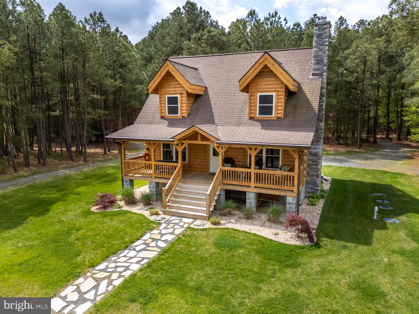 Escape to tranquility in this stunning custom-built waterfront log cabin, completed in 2022. Offering 2 bedrooms and 2 bathrooms, this charming retreat is nestled along Hudson Creek, a picturesque tributary of the historic Little Choptank River. The home boasts a beautiful eat in kitchen, living room with wood burning fireplace, and one en-suite bedroom on each level. Embrace the peace and seclusion as you step onto the property. Spend your days kayaking, fishing, and crabbing off the private dock, or wander through acres of woodlands. Unwind on the deck and soak in the breathtaking sunsets over the water, surrounded by abundant wildlife and scenic vistas. This is more than a home – it's a sanctuary, inviting you to leave the stresses of everyday life behind and immerse yourself in the beauty of the Eastern Shore. Don't miss the opportunity to make this gorgeous retreat your own slice of paradise. No flood insurance required!