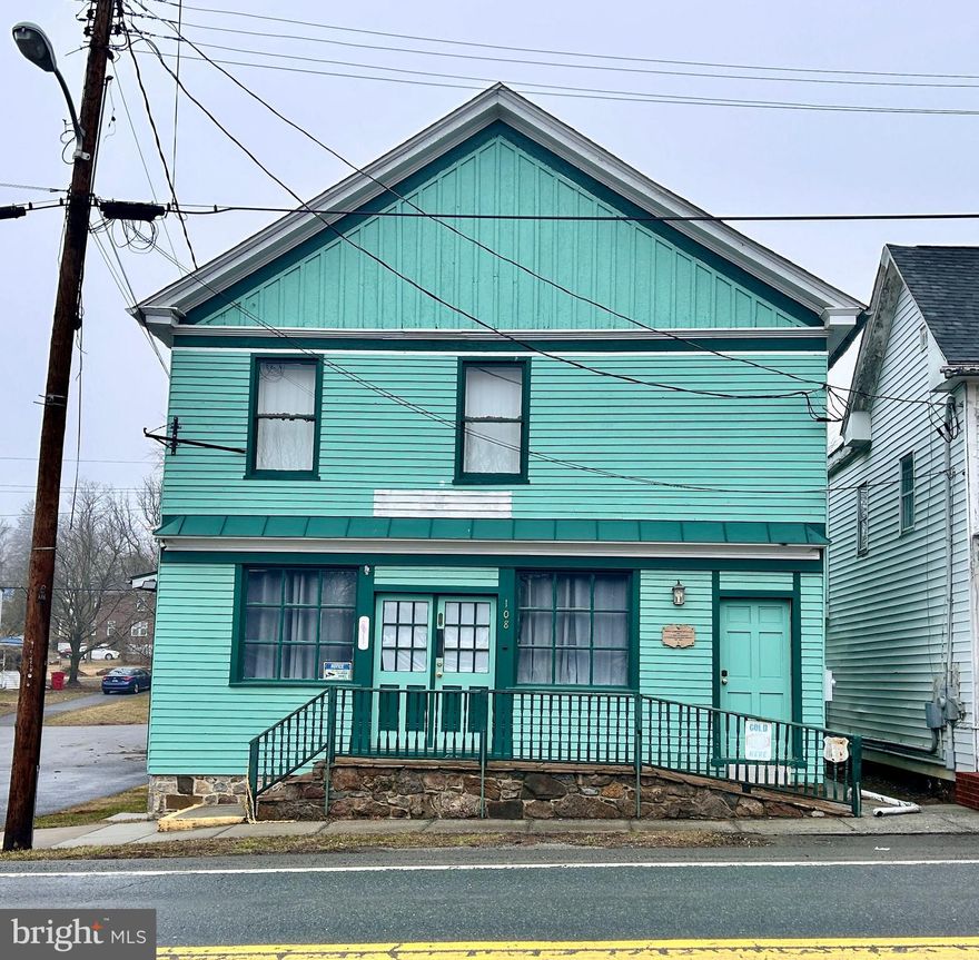 Nestled in the charming heart of Hedgesville, this beautifully preserved 2-story structure is a rare gem on the Historical Register, originally built in in the 1840's.  Once hailed as Nelson's Supply Company, which provided a convenient location to get household goods and refreshments.  Behind its unassuming facade lies an enchanting 1800 square feet interior filled with warmth, character and surprising room sizes.  As you step through the front door, you're greeted by gleaming hardwood floors that reflect the craftsmanship of a bygone era, seamlessly blending with the spacious rooms across both levels.  The structure's thoughtful layout offers the perfect balance of old-world charm and modern-day living.  New roof installed in 2019, as well as electrical upgrade the same year. There's a vibrant community just outside the doorstep, featuring homespun events like Hedgesville Heritage Days.  Believe it or not, this structure used to be the Post Office of the town!  Currently zoned as commercial, but could potentially be zoned as residential, pending Town Council review. This piece of Hedgesville's rich history can be yours and just waiting on its next chapter to be written.  Personal effects inside structure will be removed or could be negotiable items in sale.