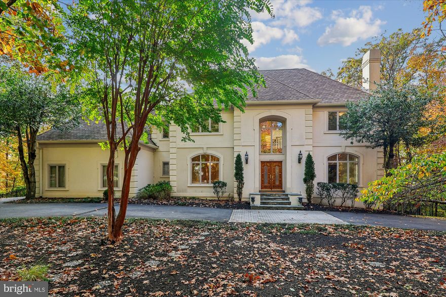 Nestled within a prestigious enclave of custom estates in the sought after community of Windsong, this magnificent luxury home commands a private, two-acre lot that perfectly balances tranquility with utility. The setting is a true escape, enveloped by mature wooded land that offers a serene buffer from the outside world. Yet, the property ingeniously includes expansive, level grassy areas, creating the ideal canvas for a variety of outdoor pursuits, from setting up play equipment to hosting large-scale yard games. This rare combination of wooded privacy and open, manicured lawn offers the ultimate environment for sophisticated living and unparalleled family enjoyment. 

Truly a unique floor plan encompassing about 6200 square feet, step into the dramatic two-story entry foyer and you're greeted by an elegant curved staircase, flanked by formal living and dining rooms designed for grand-scale entertaining with deep crown moldings and generous dimensions. The main level is graced with finished-on-site hardwood flooring that flows through almost all rooms. The heart of the home is the chef-style kitchen, wide open to an expansive family room anchored by a marble gas fireplace. This space flows seamlessly into the sunny breakfast room and kitchen.  A commanding home office features handsome built-ins and wood trim. Upstairs, discover five enormous bedrooms and three full baths. The amazing primary suite is a private retreat, boasting two walk-in closets, a sunny sitting room that would make the perfect exercise room, and a private bath ensuite. The spa-like bath is equally spacious with separate vanities, a jetted tub, and an enclosed tile shower. One additional bedroom enjoys an ensuite bath, while the other two share a buddy bath.

The seemingly endless lower level provides superb flexibility with a full-daylight rec room that walks out to a rear patio, gas fireplace, and game area. The most inviting bonus room includes a large walk-in closet and has direct access to a full bath. A sizable storage room provides ample storage space.

Outdoors you'll find a  professionally landscaped yard offering a spectacular balance of natural beauty and luxurious amenities. Mature trees throughout the property ensure ultimate privacy while creating a picturesque, natural backdrop. The expansive grounds feature both wooded areas and generous grassy open spaces, providing room for recreation and beautifully defining the property's diverse zones. 
At the heart of this retreat is the sparkling in-ground pool, perfectly complemented by a wide, sun-drenched pool patio—an ideal setting for lounging and large-scale entertaining. Adjacent to the pool area, a multi-level deck houses a relaxing hot tub, creating a seamless flow from swimming to soaking. The front of the house offers a refined welcome with a serene wooded garden complete with a tranquil water fountain, setting a calm and elegant tone for the entire estate. The public schools serving this neighborhood are Oakton Elementary, Thoreau Middle, and Oakton High. Flint Hill School (private) is also nearby.