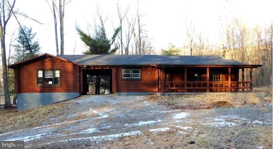 Working from home?  Come see this well-built log home. Here is your perfect office with separate entrance, lots of sun light and a half bath.  Main house is very pleasant too; great room has high ceilings, exposed beams and wood burning FP.  Hardwood floors throughout the house, large  wooded lot partially fenced and only 63 miles to DC , 23 miles to Leesburg. Huge 10K  price reduction.