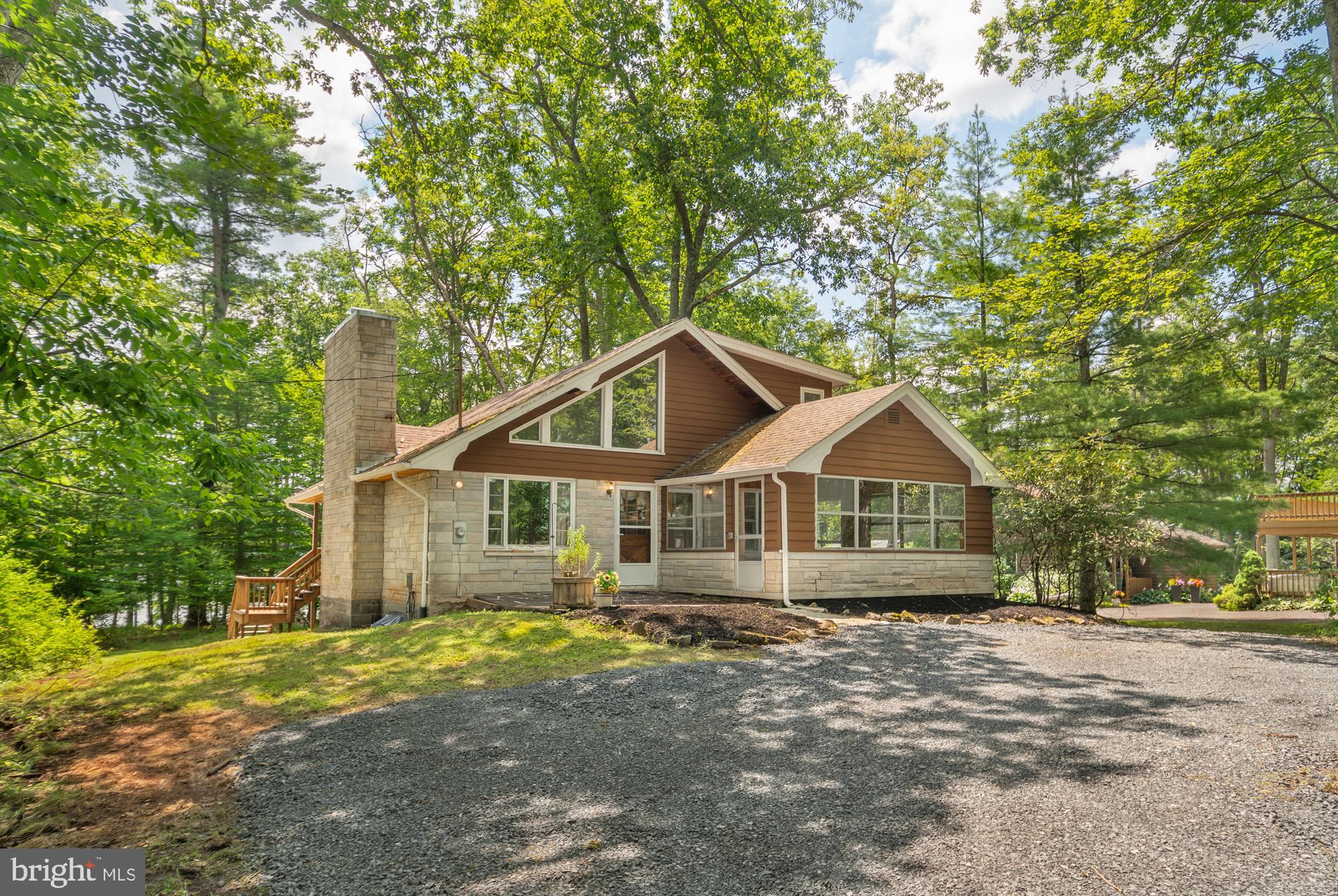 Nestled on the shores of Deep Creek Lake in a quiet cove you’ll find this quaint chalet on 117’ of waterfront. This home is just waiting for your vision to make it a lakefront masterpiece. Inside you will find a great deal of tongue & groove pine walls and ceilings, and oak floors. Offering three bedrooms, hardwood flooring, cathedral ceilings, stone wood burning fireplace and a nice sunroom. The lakefront views can be enjoyed from most rooms. Once you step outside, the partially covered wrap around deck is ideal to entertain family and friends. Take a few steps and you are enjoying the lakefront with a private, Type A dock. The central lake location is just minutes to DCL State Park, restaurants, cinema, ice cream, coffee, and shopping. Call today to preview!