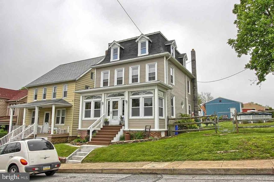 This home has plenty of updates and plenty of history. Historical woodwork and HW floors in the huge LR.  Home has new windows, new baths, new kitchen, new boiler,new electric, and new flooring. A must see home to appreciate the updates and the history!  Detached oversize 2 car garage sits at the end of the fenced backyard.