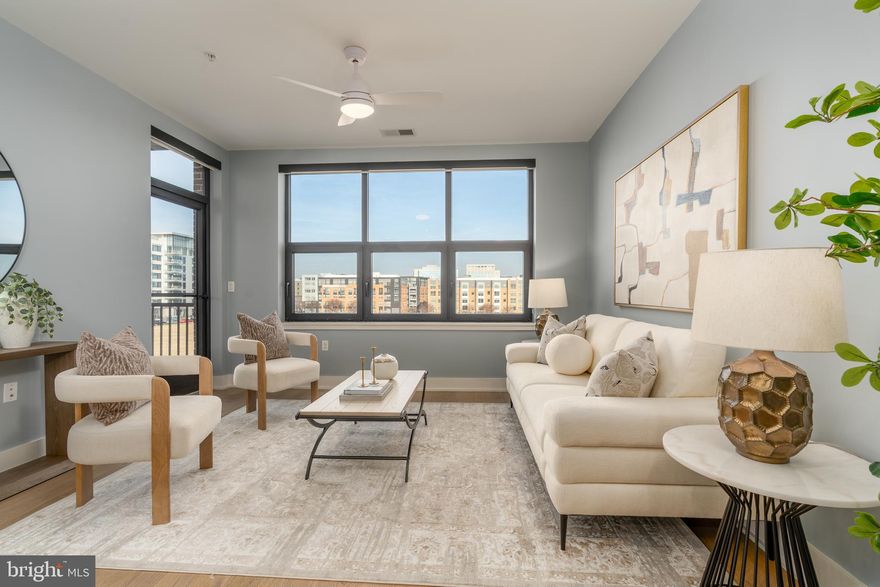 Incredible value...Introducing an exceptional nearly new residence at The Dylan at Potomac Yard, offering sophisticated condominium living with iconic views of the Potomac River and the U.S. Capitol. This thoughtfully designed one-bedroom plus den, 1.5-bath home showcases top-of-the-line finishes throughout and includes one generous parking space along with the largest private storage unit in the building.

The open-concept living space is anchored by a stunning chef’s kitchen featuring quartz countertops with full-height backsplash, imported Italian soft-close cabinetry, a Fisher & Paykel panelized refrigerator, Bosch appliances, center island with wine refrigerator and abundant storage—perfect for both everyday living and entertaining. The dedicated work-from-home den, paired with a convenient powder room, provides an ideal and private workspace away from the main living areas. Enjoy the views from your own private balcony.

Retreat to the spa-inspired primary bath, beautifully appointed with Waterworks fixtures, LED backlit mirrors, a built-in linen closet, and additional Italian cabinetry. The primary suite is completed by a lavish, custom walk-in closet, offering exceptional organization and style.

Residents of The Dylan enjoy an impressive suite of amenities, including a rooftop outdoor dining terrace with panoramic views, rooftop party room, fitness center, arts and creative room, full-time concierge, and on-site resident manager. Ideally located just moments from Potomac Yard Metro, Potomac Yard Park, Del Ray, and the newly opened Founding Farmers restaurant directly across the street, this remarkable home delivers luxury, convenience, and breathtaking views at an exceptionally accessible price point.

This unit includes one assigned, dedicated parking space (S-138) and the largest storage space (48) within the property measuring 6.5 x 16 feet that both convey.