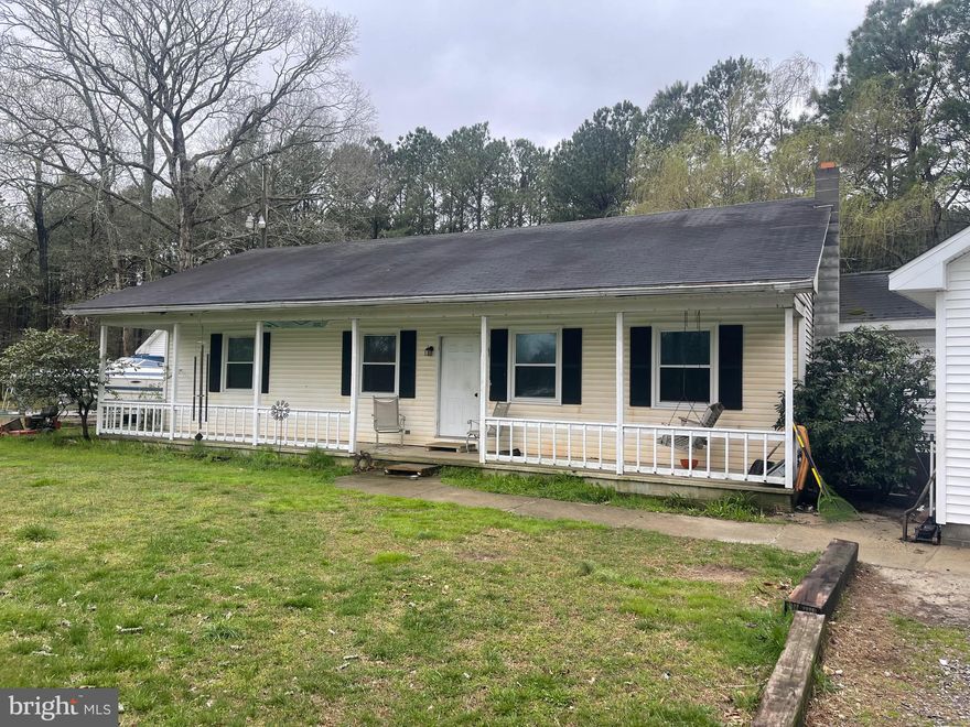 Just over a  One Acre Parcel with a 4 bed 2 bath house with an attached and detached 2 car garage. 4 total garage spaces.  This is a handyman special!  Have your business in one garage and have a garage for your cars.  Located less than 1 mile from 113 and 10 miles from Ocean City.