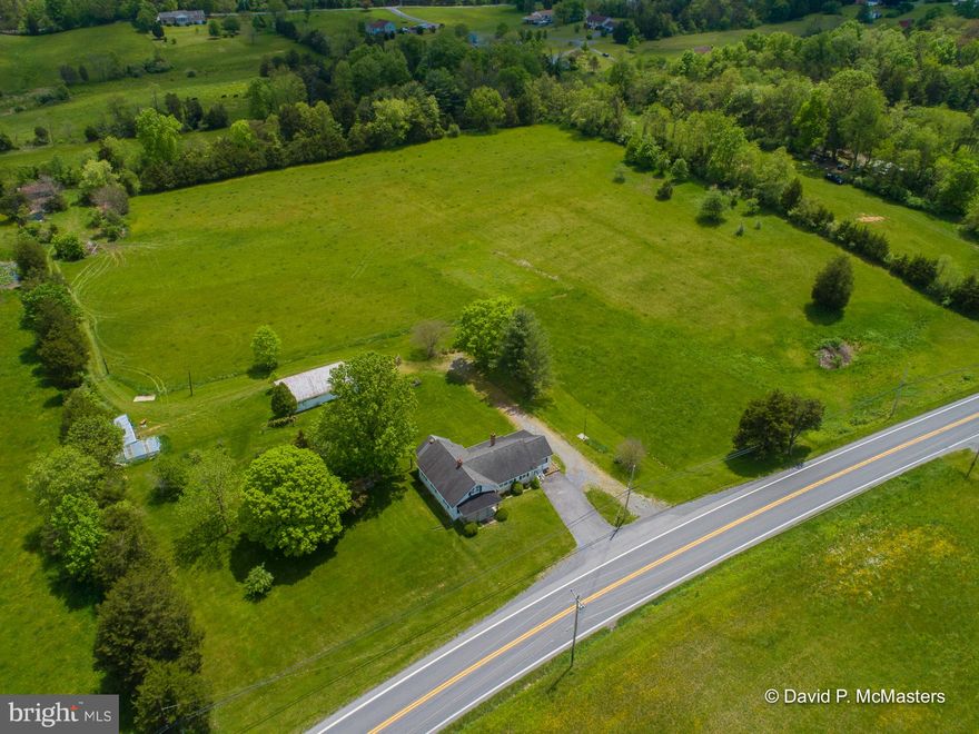 An absolutely gorgeous piece of land. Level and cleared.  So here's your farmette ready to go. Have animals, plant crops -- perfect spot for that.  The electrical system in the home was recently upgraded.  The home is perfectly livable and comfortable but the buyer may want to make some cosmetic upgrades -- that hasn't been done for a while.  The location - fronting Hedgesville Rd - is a great business location. The only restriction is that alcohol can't be sold.    2 lots totalling 8.76 acres. The home is on 3.76 acres. Live in that home while you build another home on the adjoining lot which is on 5 acres. Getting hard to find a home with this kind of acreage.