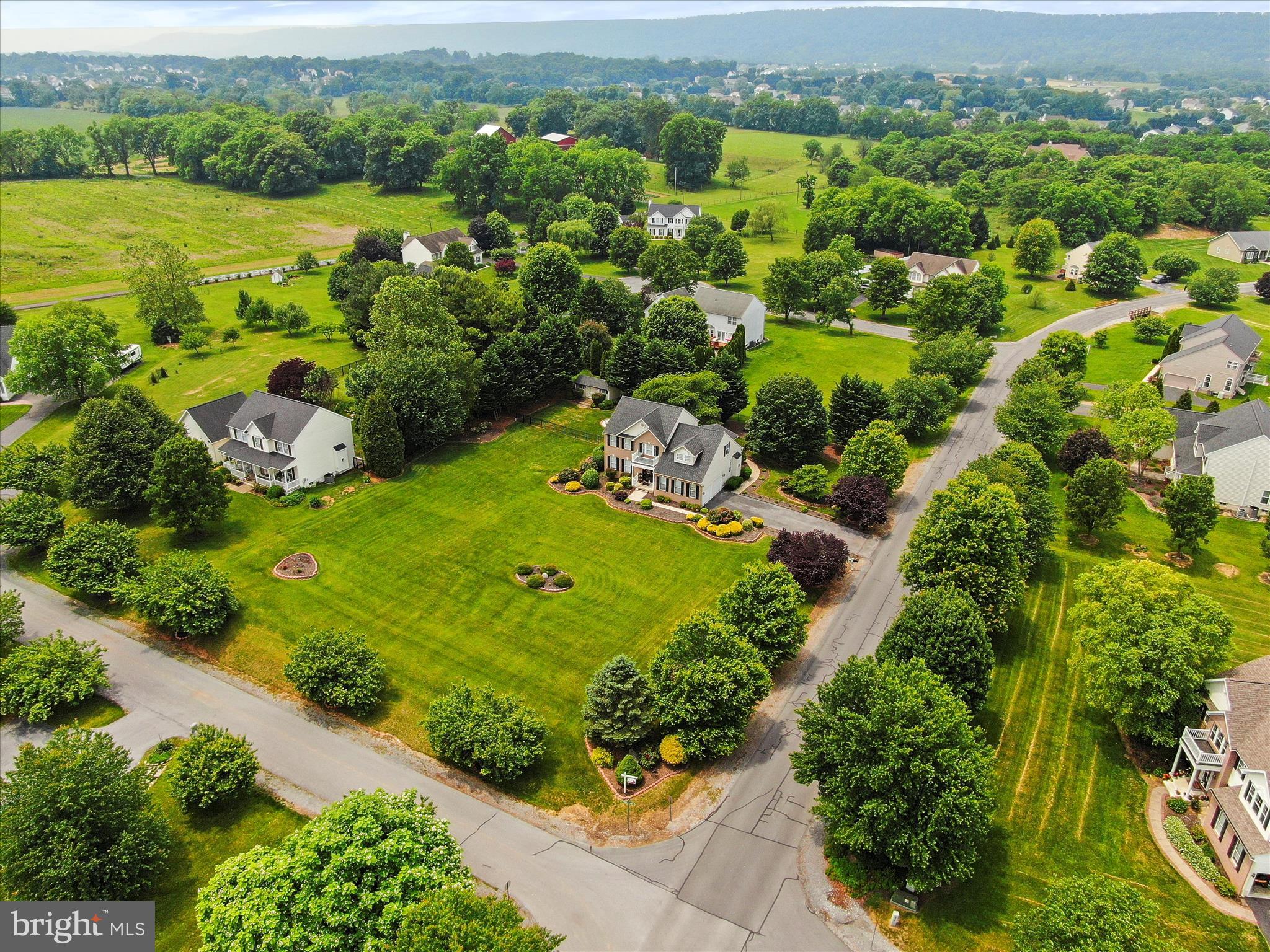 Where a touch of Luxury meets affordability. Welcome Home to 20 Cobblestone Ct. A Martinsburg address in Hedgesville District. This lot brings peace and serenity of a rural area and is only 5-6 minutes from I -81 and a few more mins to schools and shopping.
Stunning 1.01 Acre corner lot in the desirable Harlan Run.
This large Brick Colonial has been VERY well taken care of with all the updates one would want in a home including LVP throughout, Roof less than 5 years old, new Trane HVAC, an extra-large Commerical grade French door refrigerator, stove and hood, marble countertops, farm sink, slide out cabinets for your ease to reach your pots and pans, recessed lighting, large pantry with huge sliding barn doors between kitchen and dining / sitting area and so much more in this are of the home. The Kitchen is open to the living room that has tall, vaulted ceilings, a propane fireplace (not currently in use) large windows throughout with custom fitted window treatments. Open your back door that serenity I first referenced and let the air flow through your home with a very nice screened in back porch, to enjoy your mornings & evenings, carpeted and fitted with roll down sunshades. A walk through the fenced in back yard (double gated for mower) takes you to the Hot tub and scenic firepit area to spend time with family and friends for many memories surrounded by beautiful landscaping. The back yard also features a large 12*20 shed that has electric, and A/C. Lets go back in. Oversized 2 car garage features extra shelving for storage, refrigerator and as you walk into the mud room the lights are connected to a motion sensor to activate at your movement. On the main level is a bedroom that has been converted and currently used as an office but can easily be converted back with a half bath on this level as well. A waltz upstairs where you'll find the convenience of the laundry at the bedroom level. The Huge Primary bedroom with vaulted ceilings has a beautiful bathroom suite, double vanity granite sinks, marble walk in shower, separate soaking tub, large walk-in closet with plenty of shelving. The 4th bedroom upstairs has been opened up to the Primary bedroom as a sitting room but can be converted back if you wish. Upstairs you'll find 2 more bedrooms and a full bath. The Basement is fully finished and ready to be an In - Law suite if you desire with a full bathroom, rec room / bedroom. The pool table, tall table and chairs, refrigerator also convey. You really need to see this to appreciate, schedule your tour today.