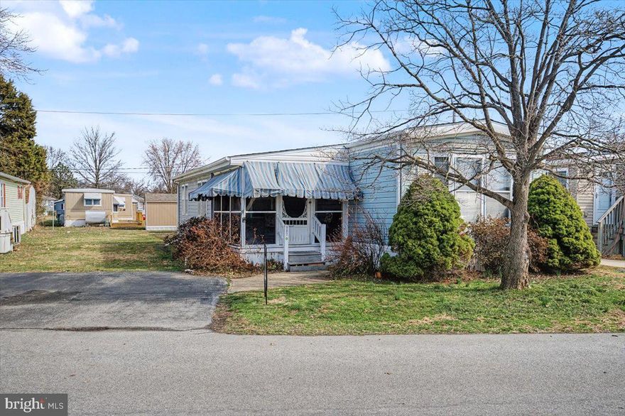 Monthly lot rent is $808.  Welcome to this beautifully maintained 2-bedroom, 2-bath double-wide home in the desirable Murray Manor community. Freshly painted throughout, the home features brand-new carpeting in the living room and bedrooms, new vinyl flooring in the kitchen, and several new windows that enhance natural light. The spacious layout includes two generously sized bedrooms, including a private primary suite with its own full bath. A large laundry room with a washer and dryer included adds everyday convenience. A major recent improvement is a brand-new roof installed in 2026 for added peace of mind. Enjoy morning coffee or evening relaxation on the inviting front sitting porch. Affordable lot rent includes water, trash, and Xfinity cable, making this home an excellent value. Available for immediate occupancy—schedule your showing today!