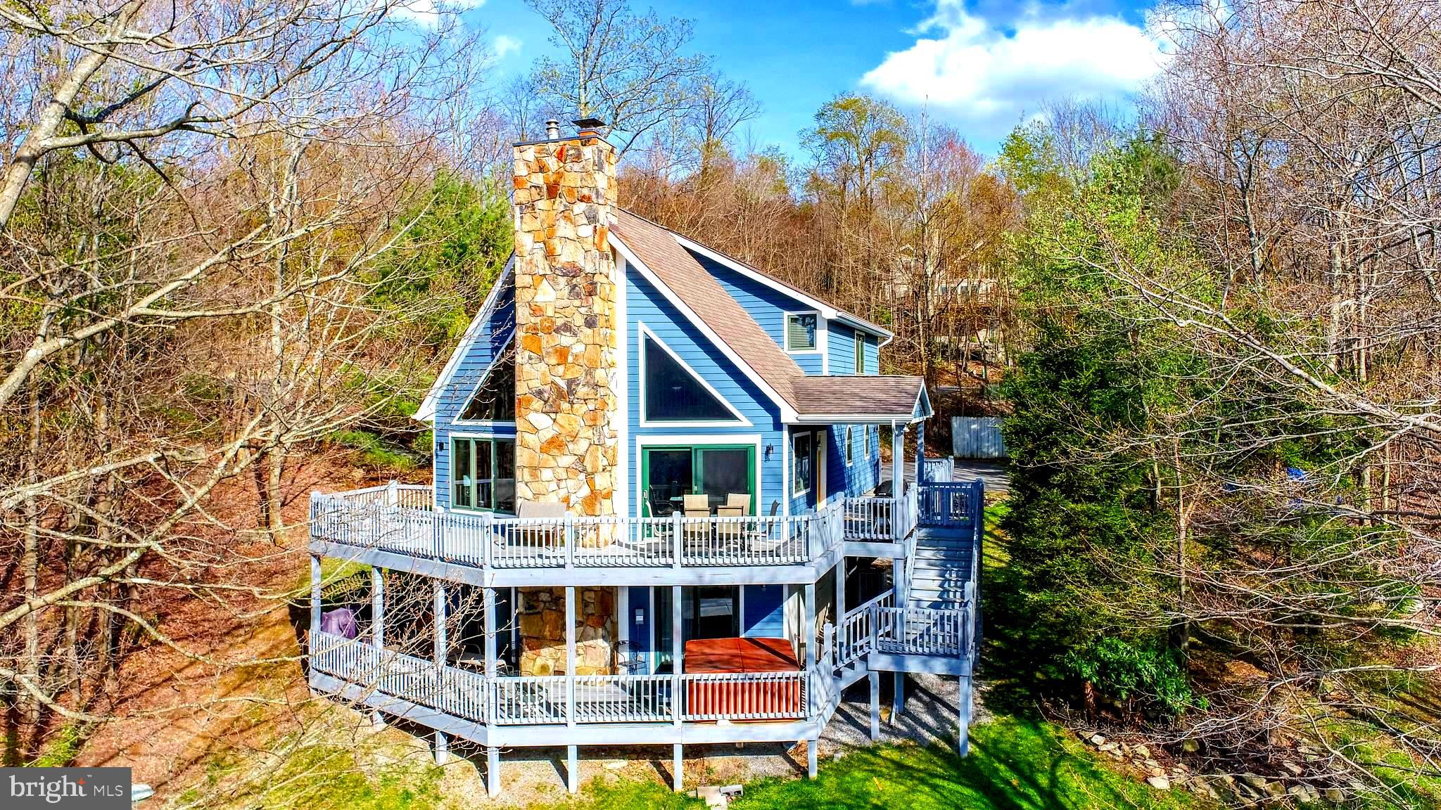 Escape to your private mountain retreat in this 4-bedroom, 3-bath chalet-style home, perfectly perched to capture incredible lake and mountain views. This thoughtfully designed home offers a warm, rustic-modern aesthetic with vaulted ceilings, expansive windows, and an open-concept layout ideal for entertaining or relaxing by the fire. The kitchen flows seamlessly into the dining and living areas, all opening to a wrap-around deck where panoramic views provide the perfect backdrop for morning coffee and beautiful sunsets.
This home will convey turn-key and is ready for rest & relaxation! Enjoy the convenience of this location to Deep Creek Lake and all the amenities and activities it provides.