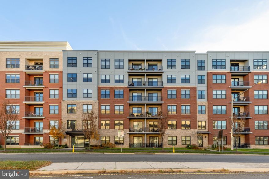 Experience refined luxury living in this turn-key 2-bedroom, 2-bath corner condo spanning 1,546 sqft in the sought-after 55+ community of The Atrium at MetroWest. Step through the foyer into an expansive open floor plan filled with southern exposure and abundant natural light. The home features high ceilings and gleaming hardwood floors throughout the hallway, kitchen, and family room. The gourmet kitchen is a chef’s dream, offering granite countertops, stainless-steel appliances, a pantry closet, and a large island with bar seating—perfect for casual meals or entertaining guests. Walls of windows fill the dining and living areas with sunlight, creating a warm and inviting atmosphere. Step out onto the spacious balcony to enjoy fresh air and open views and overlook the courtyard. The primary suite includes two oversized walk-in closets, a spa-inspired bath with dual vanities, and a linen closet for extra storage. The second bedroom and full bath offer equal comfort, ideal for guests or a home office. Additional features include custom window treatments, a full-size laundry closet, and two extra storage/coat closets. This unit also comes with two assigned garage parking spaces G29 and G30 with short distance to elevator and secure coded garage entry for convenience. Enjoy resort-style amenities at The Atrium: a heated indoor pool, fitness center with yoga room, entertainment lounge with full kitchen, beautiful courtyard with grilling/dining area, and a quiet library. Located just minutes from the Vienna Metro, I-66, and downtown Vienna, you’ll have quick access to parks, walking trails, and premier shopping, dining, and entertainment in the Mosaic District. Live the elevated lifestyle you deserve—right here at The Atrium at MetroWest.