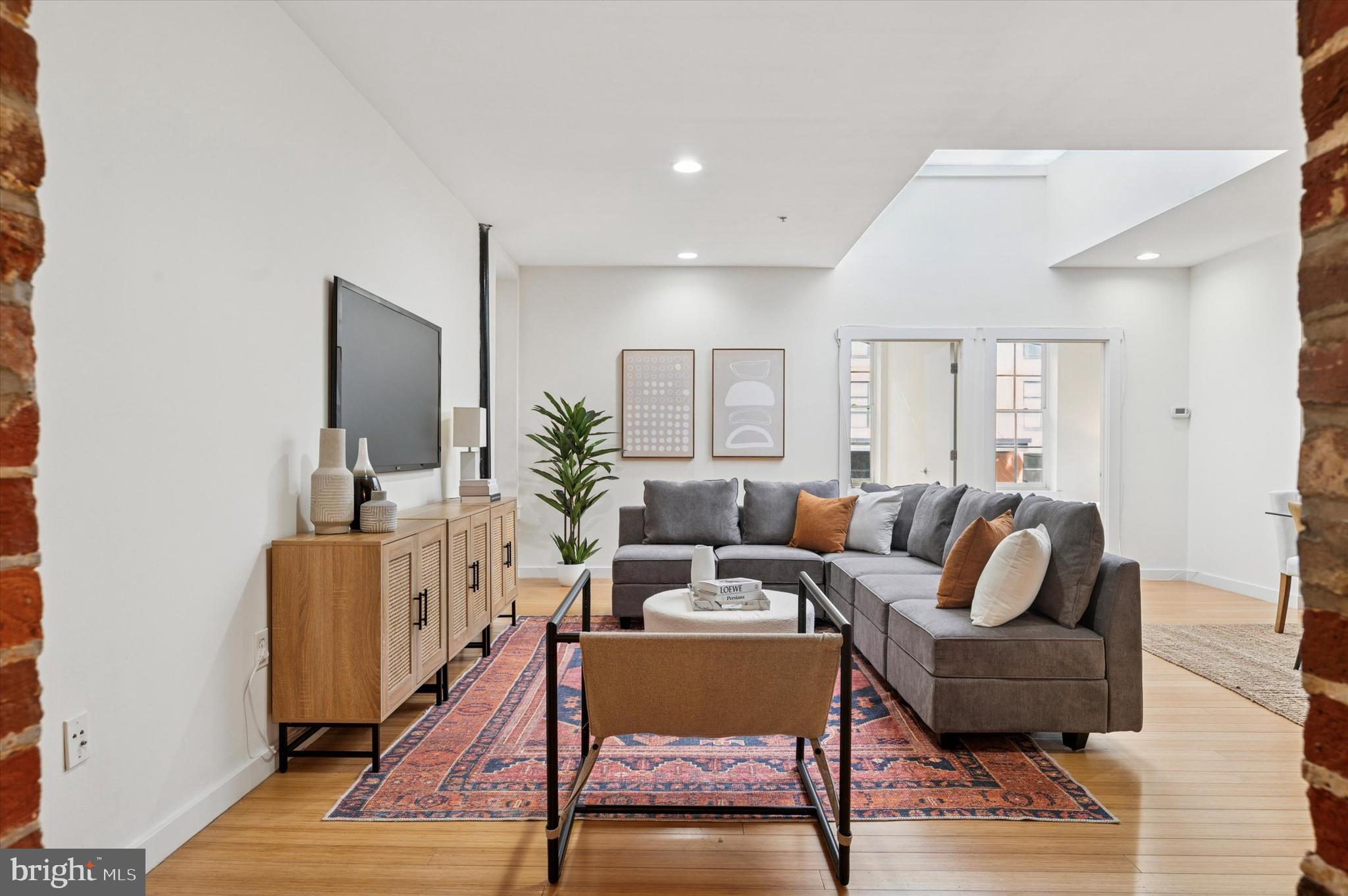 Welcome to 209 Cuthbert Street, Unit 104! Located in a boutique loft building on a quaint side street in the heart of historic Old City, Philadelphia, this spacious 2 bedroom, 1 bathroom condo expertly blends modern amenities with historic industrial charm. As you enter the home, you’ll be greeted by the stunning exposed brick pillars that frame the large foyer. Two sizable closets and ambient lighting complete the entryway. Up a small flight of stairs is the expansive, sunlit living and dining area, perfect for entertaining. Exposed brick walls, exposed ductwork, beautiful hardwood floors and a large skylight highlight the truly unique space. The galley style kitchen offers plenty of storage and makes meal prep easy. It features wood cabinets, a sleek countertop and stainless steel appliances. Oversized windows, hardwood floors, an exposed brick wall and an ample sized closet complement the bedrooms located off the main living area. The bathroom has a subway tiled bathtub and has been newly updated with a crisp white vanity and double sconces. The Bosch washer and dryer are stacked in the bathroom and a storage locker is in the basement. The building features a shared roof deck to bask in the fresh air while enjoying the beautiful skyline and river views. With a neighborhood walk score of 99, you’ll enjoy the easy convenience of city living with close proximity to Old City’s best restaurants, shops, art galleries, historic attractions and public transit. This home makes traveling a breeze with its accessibility to I-95, 676 and the Ben Franklin Bridge. Experience life at the Cuthbert Lofts, where history meets modern living.