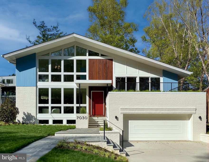 Welcome to 7030 Oregon Ave NW, a newly-built home showcasing authentic Mid-Century Modern design. Featuring seamless indoor-outdoor living, it offers clean lines, floor-to-ceiling windows, and a striking single-gabled roof. A massive three-level stacked bond masonry chimney, with wood-burning fireplaces on each floor, houses a distinctive kitchen alcove and a two-story hallway bathed in natural light from six skylights.
The main level boasts a wall of windows overlooking Rock Creek Park, an indoor-outdoor planter box, tongue-and-groove beamed ceilings, a two-story pulled-away hallway, a custom built-in wall, and aligned views of the rear yard. The expansive living area includes an oversized family room and a custom kitchen with island seating for five, a Blue Star gas range, panel-front dishwashers, quartzite countertops, and a Fireclay tile backsplash. The dining room, with beautiful lighting, includes a custom wet bar with two wine refrigerators, a four-panel sliding door to the rear yard, a lounge area, and an accordion door opening to a screened-in porch. Outside, a private yard with a fire pit, cascading waterfall, and custom fence creates a relaxing oasis. A custom powder bathroom, large pantry, and guest coat closet complete the main level.  
The upper levels offer five spacious bedrooms, a separate office, four full bathrooms, a bright hallway, and a green roof deck with views of Rock Creek Park. The primary suite features park-facing windows, volume ceilings, a wood-burning fireplace, retro lighting, and a spa-like bathroom with custom tiles and skylights. Two companion bedrooms each have volume ceilings, en-suite bathrooms, and walk-in closets. Bedrooms four and five share a beautiful bathroom and have large closets. Additional features include a laundry room and a hidden kids-only loft.  The oversized two-car garage leads to a functional mudroom with ample storage and a custom dog bath. A guest suite is located on this level, as is an incredible family room with 9'+ ceilings, a wood-burning fireplace, a custom dry bar, and a large gym with an egress door. The lower level also includes a second oversized laundry room and 260 sq. ft. of dedicated storage.  Step outside to direct access to Rock Creek Park, where miles of hiking and biking trails await, perfect for exercise, exploration, and immersing yourself in nature, all while being in the heart of DC. Stroll to Candy Cane City playground and Rec Center. Less than 10 minutes to Friendship Heights metro, Downtown Bethesda, Amazon Fresh, Conn Ave shops and restaurants, Chevy Chase Club and Columbia Country Club. Lafayette/Deal/Reed school pyramid.